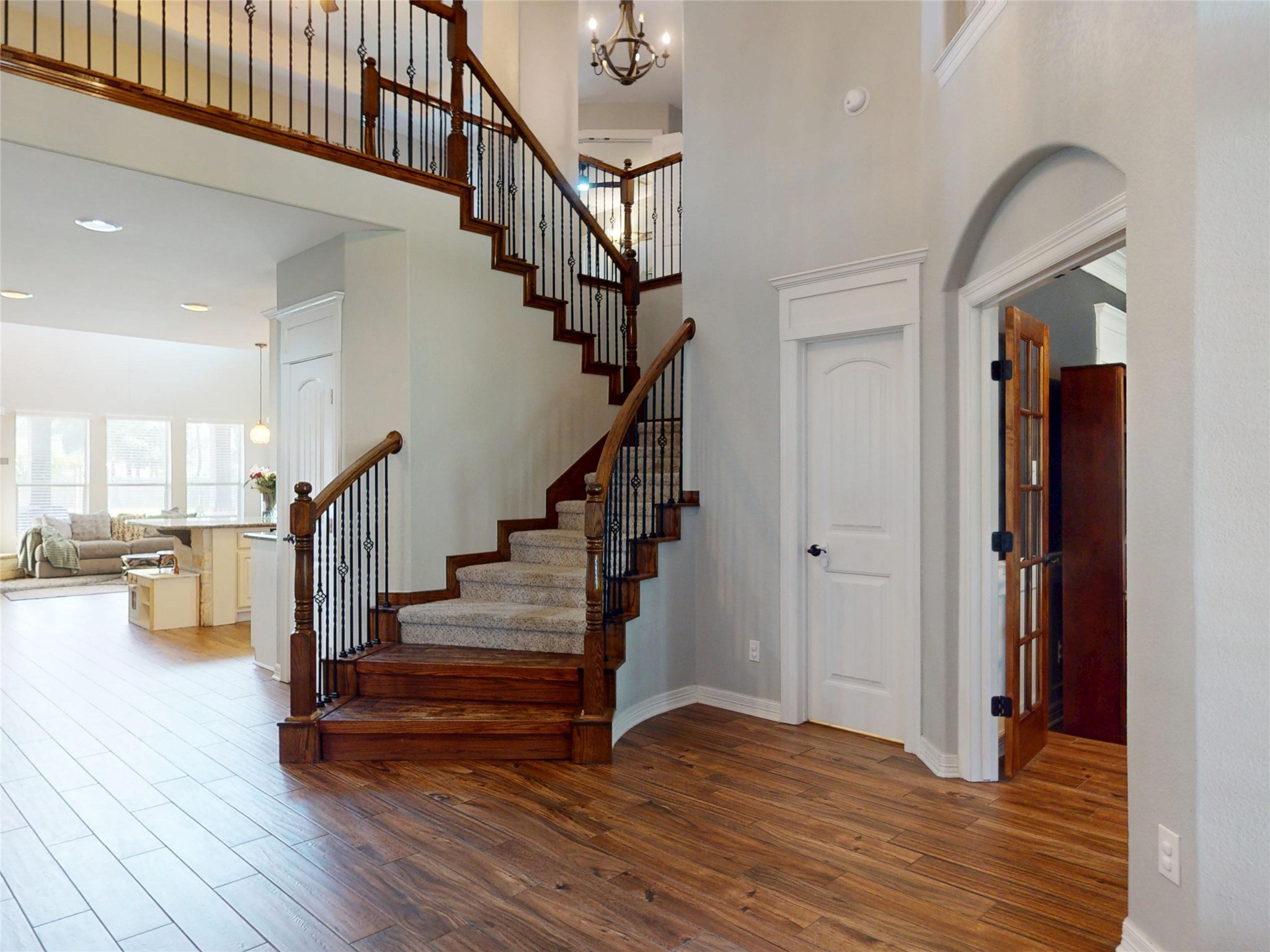 Two-story entry with wood stairs and iron balusters