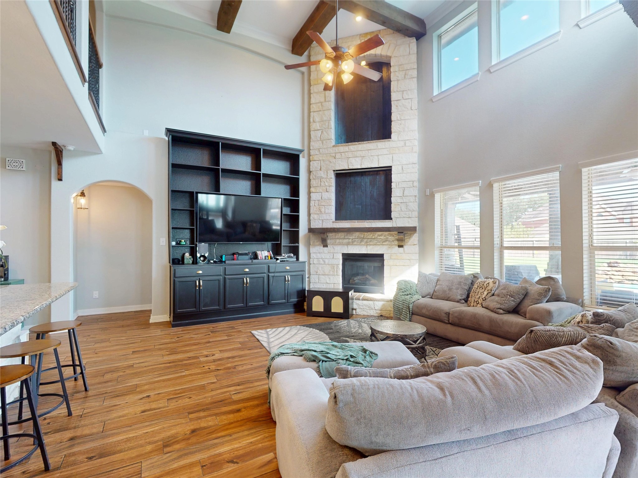 Built-ins flank the fireplace beneath exposed beams