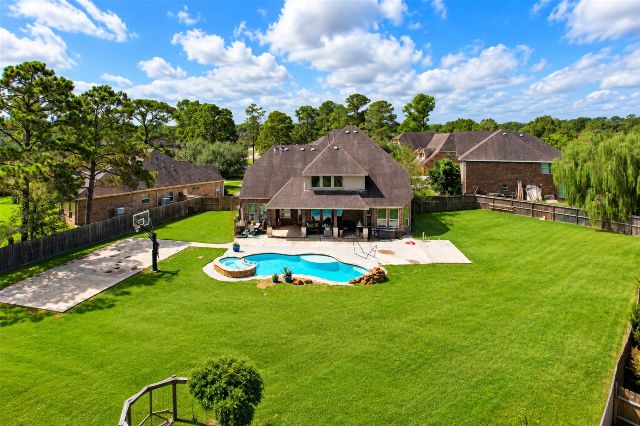 Aerial of the rear - pool, spa and oversized fenced yard