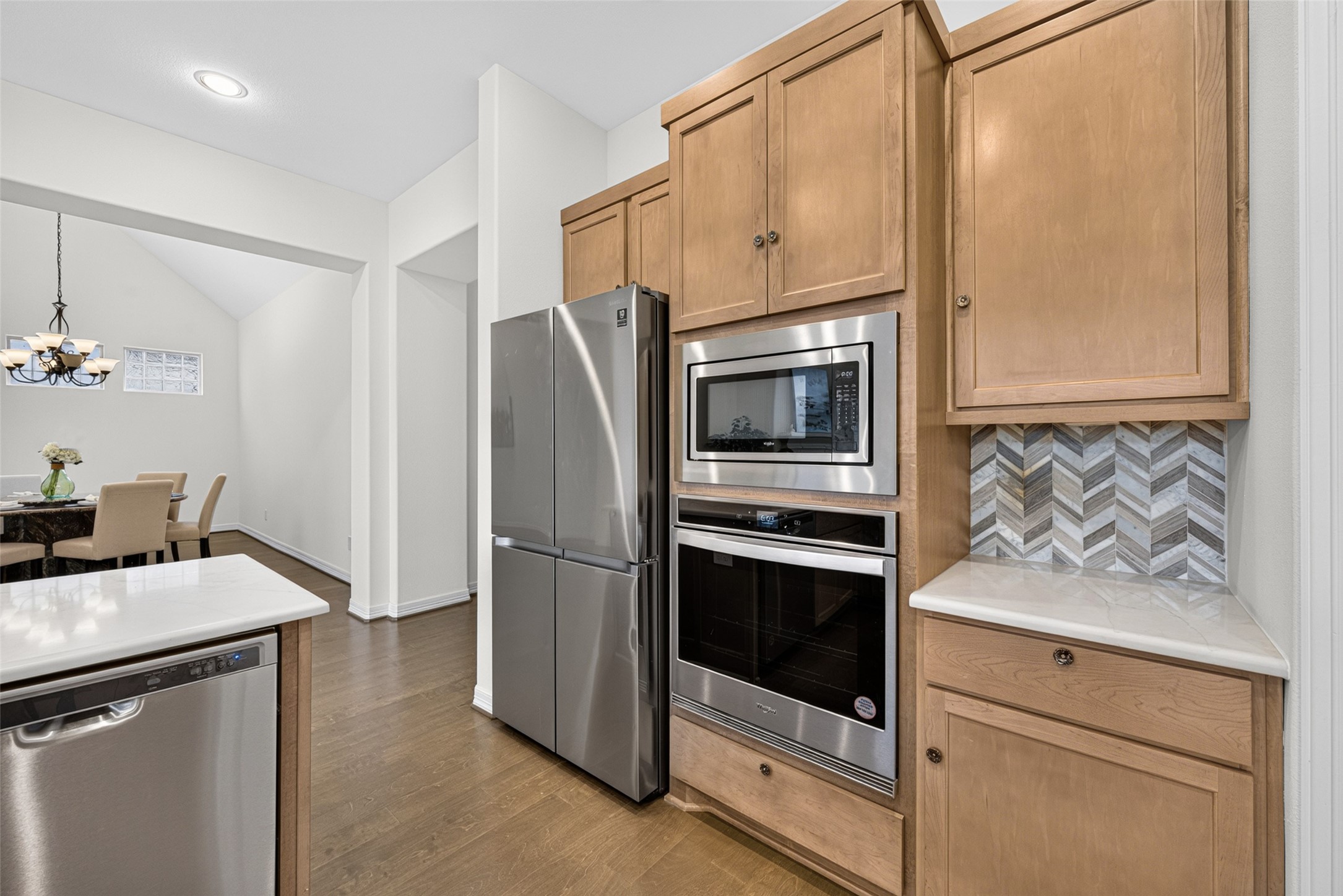 Modern stainless steel appliances seamlessly integrate into the cabinetry, offering performance and sleek appeal for the home chef.