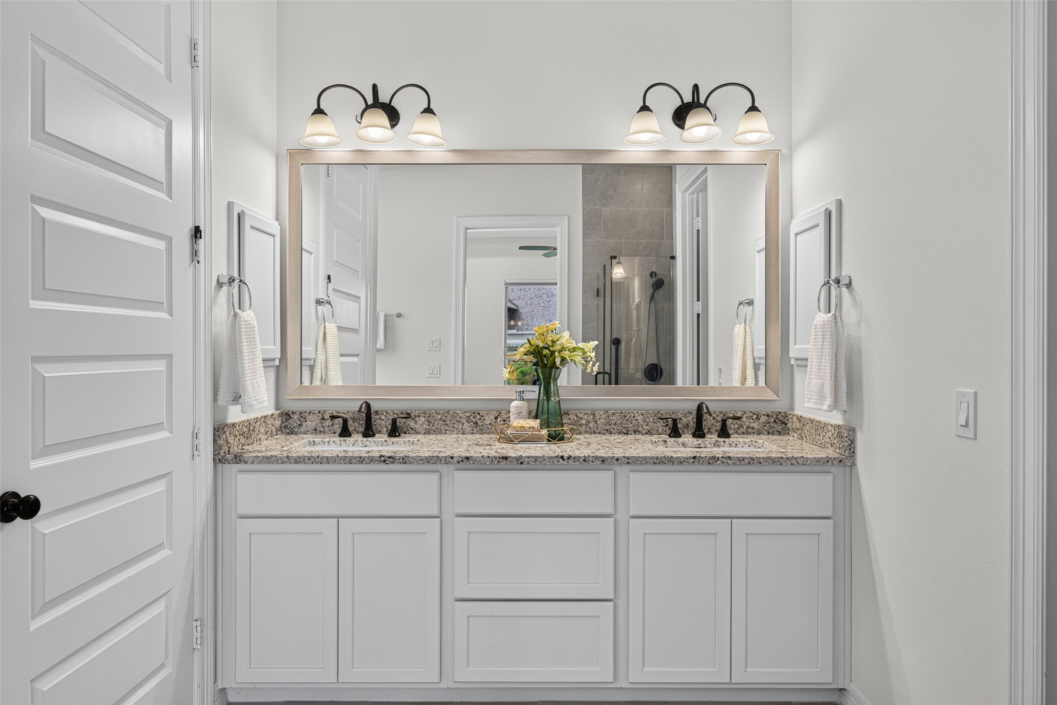 Step into a private spa-like haven designed for total relaxation and self-care. The sleek vanity area features ample counter space and storage, making morning routines effortlessly smooth for two.
