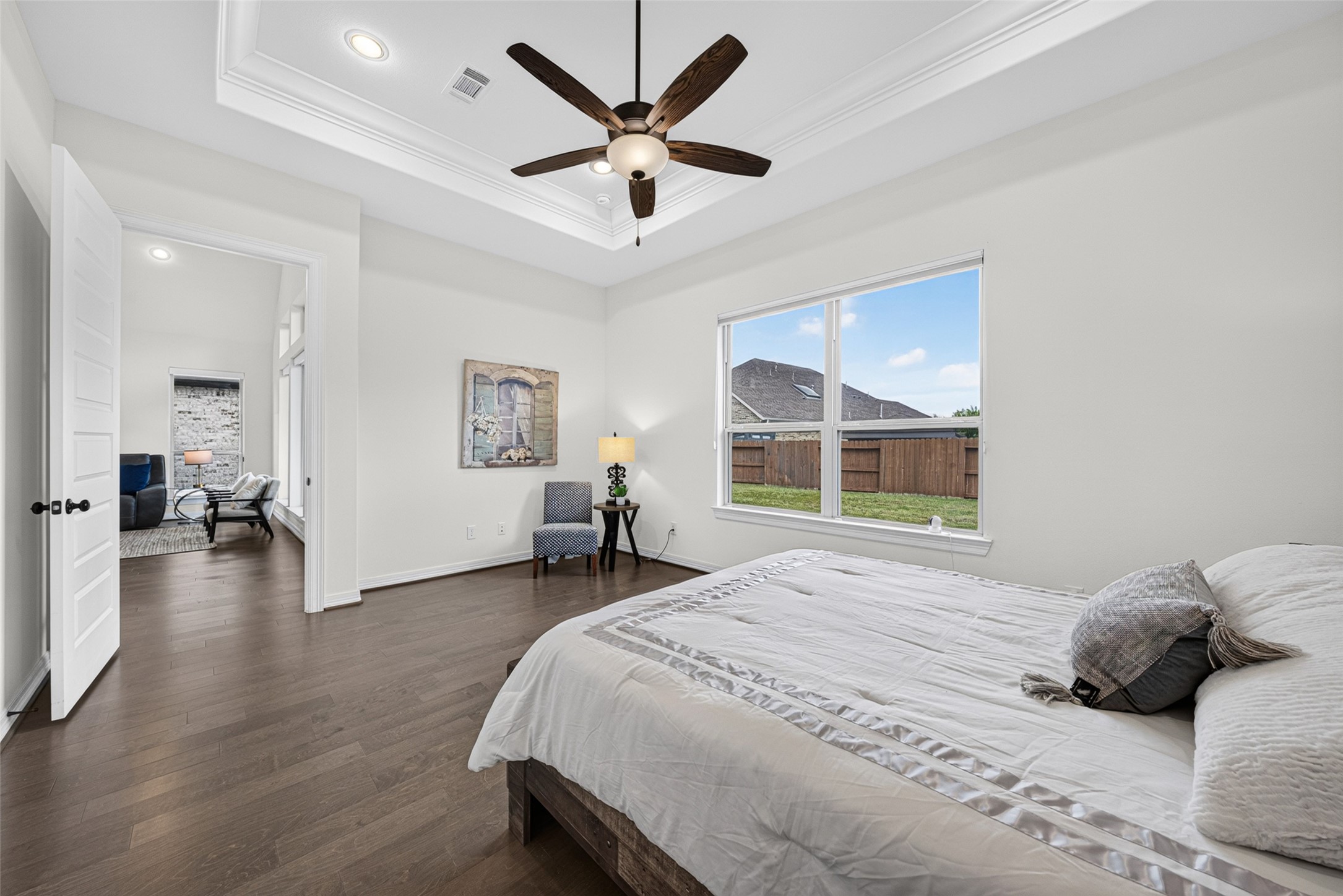 Wide window frames delightful views of the lush backyard, filling the room with soothing natural light each morning.