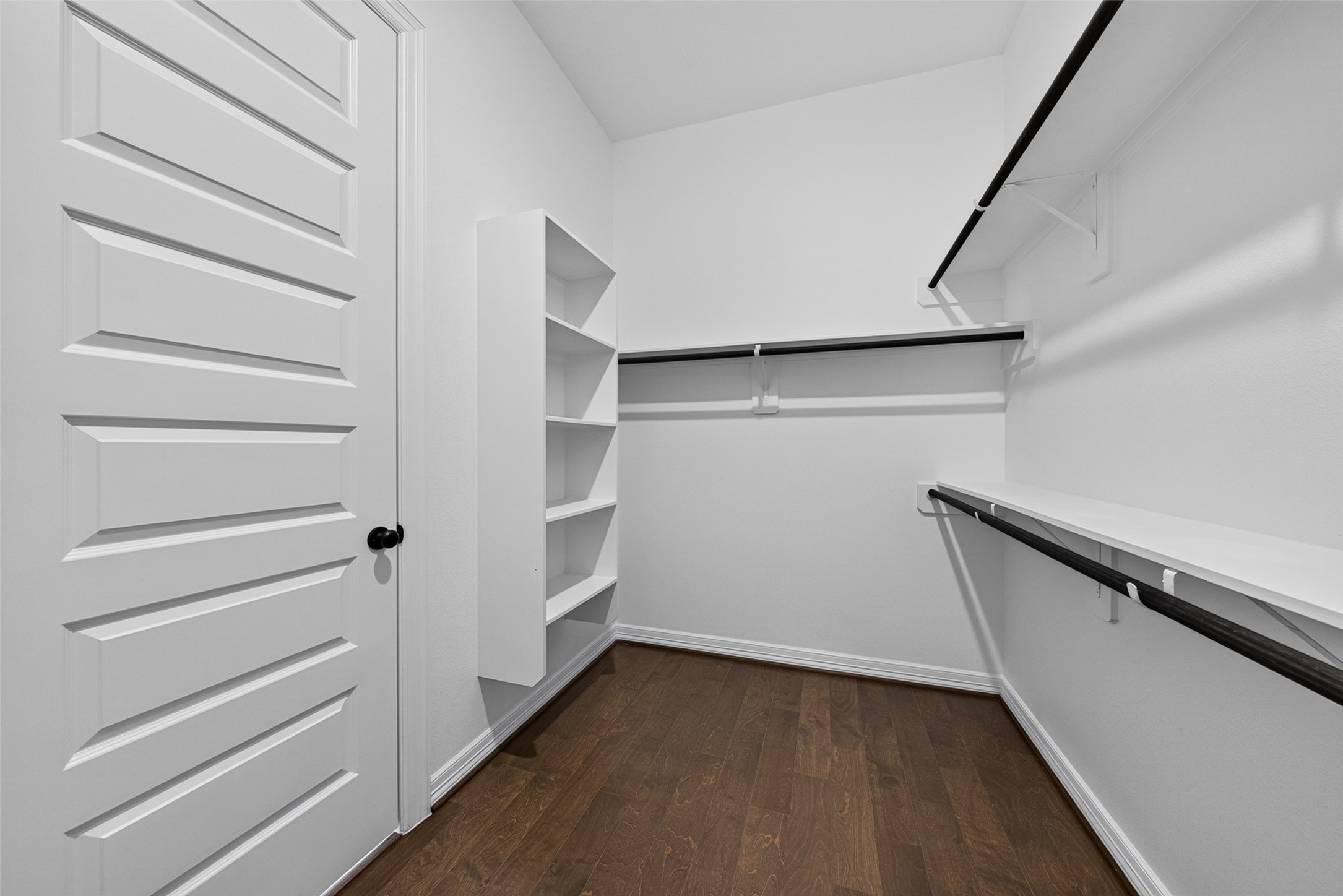 Thoughtfully arranged with tailored compartments and versatile storage, this closet effortlessly accommodates shoes, accessories, and seasonal wear.