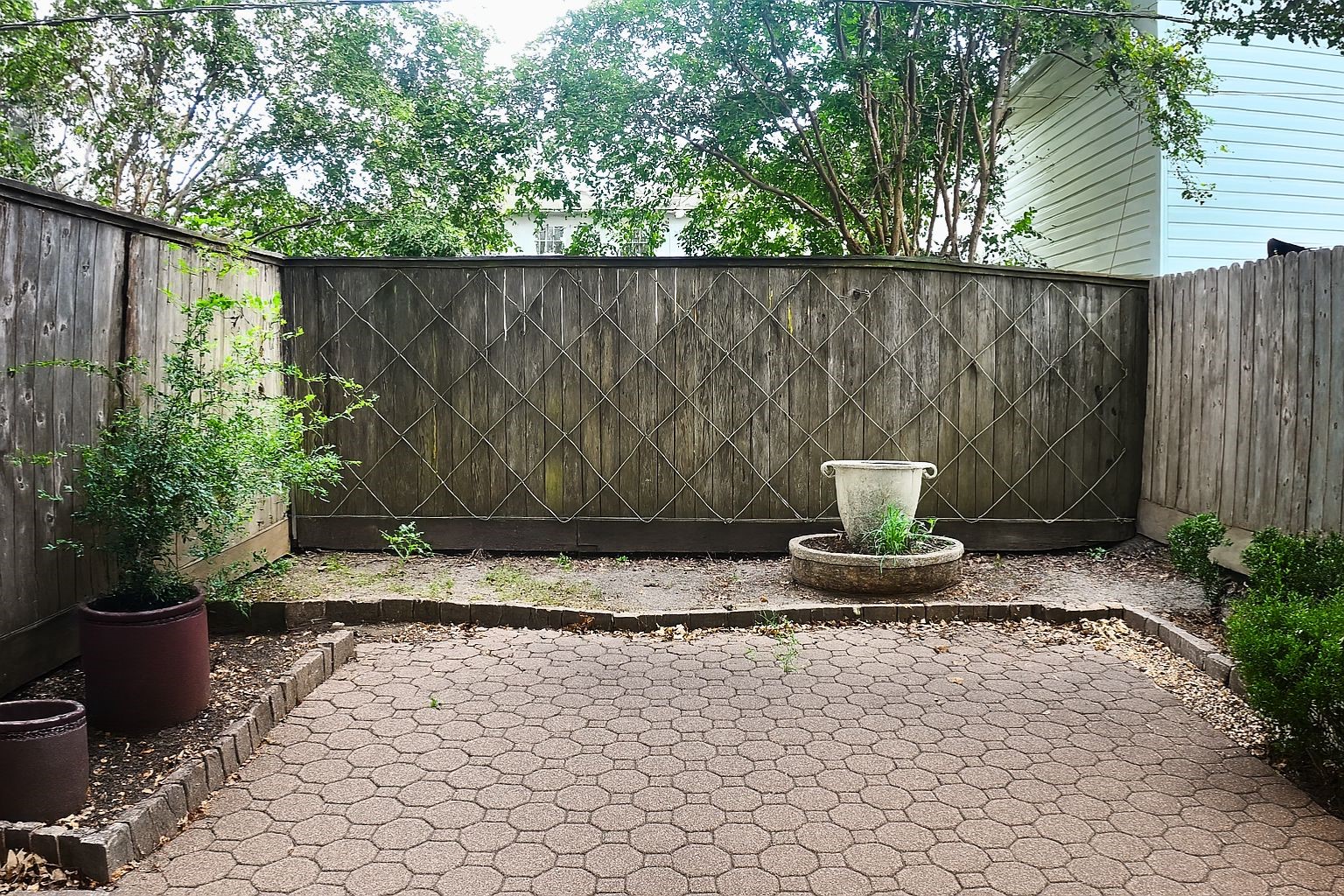 Step outside to a private backyard, enclosed by fencing for privacy, with low-maintenance hardscaping and space for planting or entertaining.
Step outside to a private backyard, enclosed by fencing for privacy, with low-maintenance hardscaping and space for planting or entertaining.