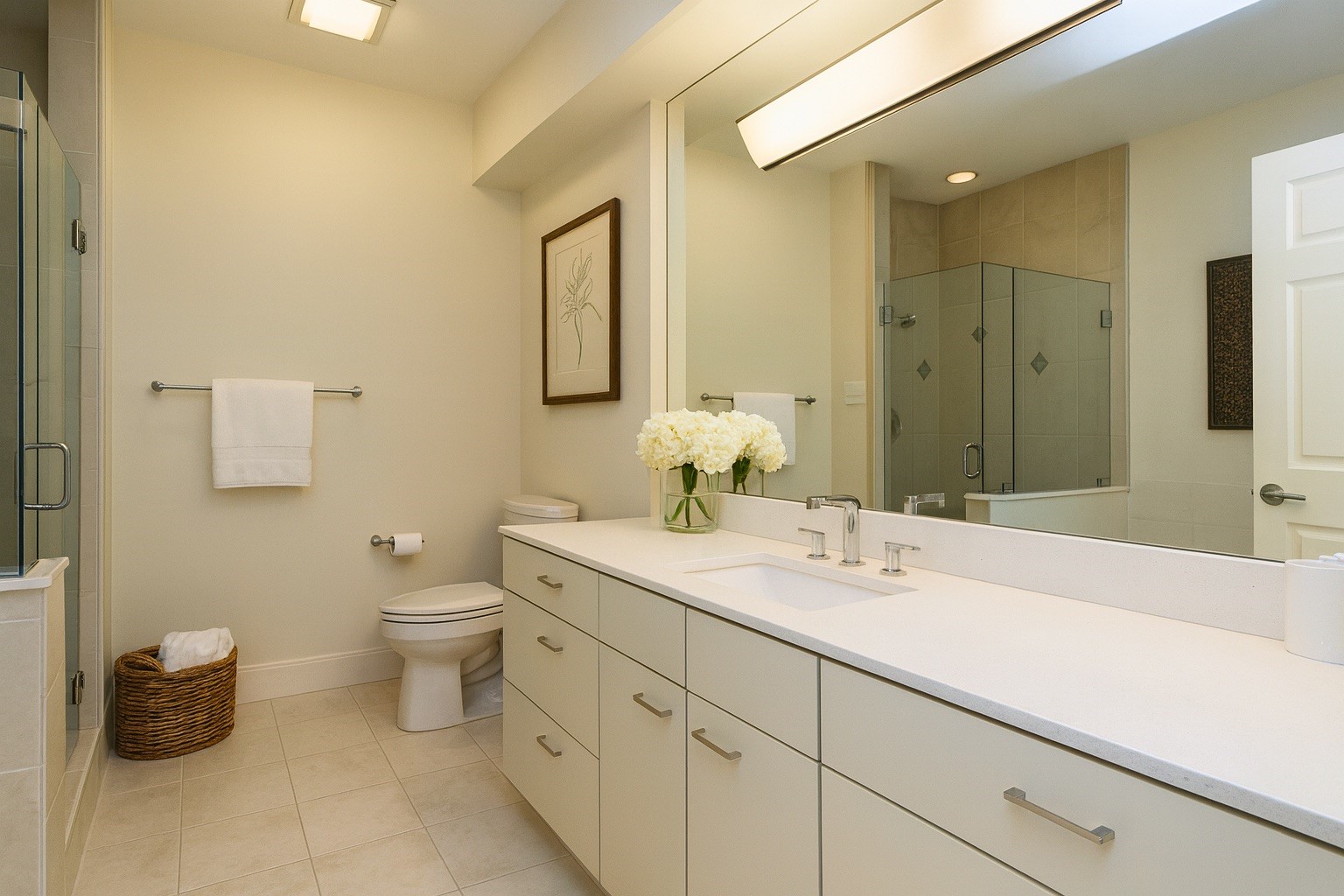 In the primary bathroom (digitally staged), youll find dual vanities, abundant storage, and a walk-in glass shower that feels bright and refreshing.