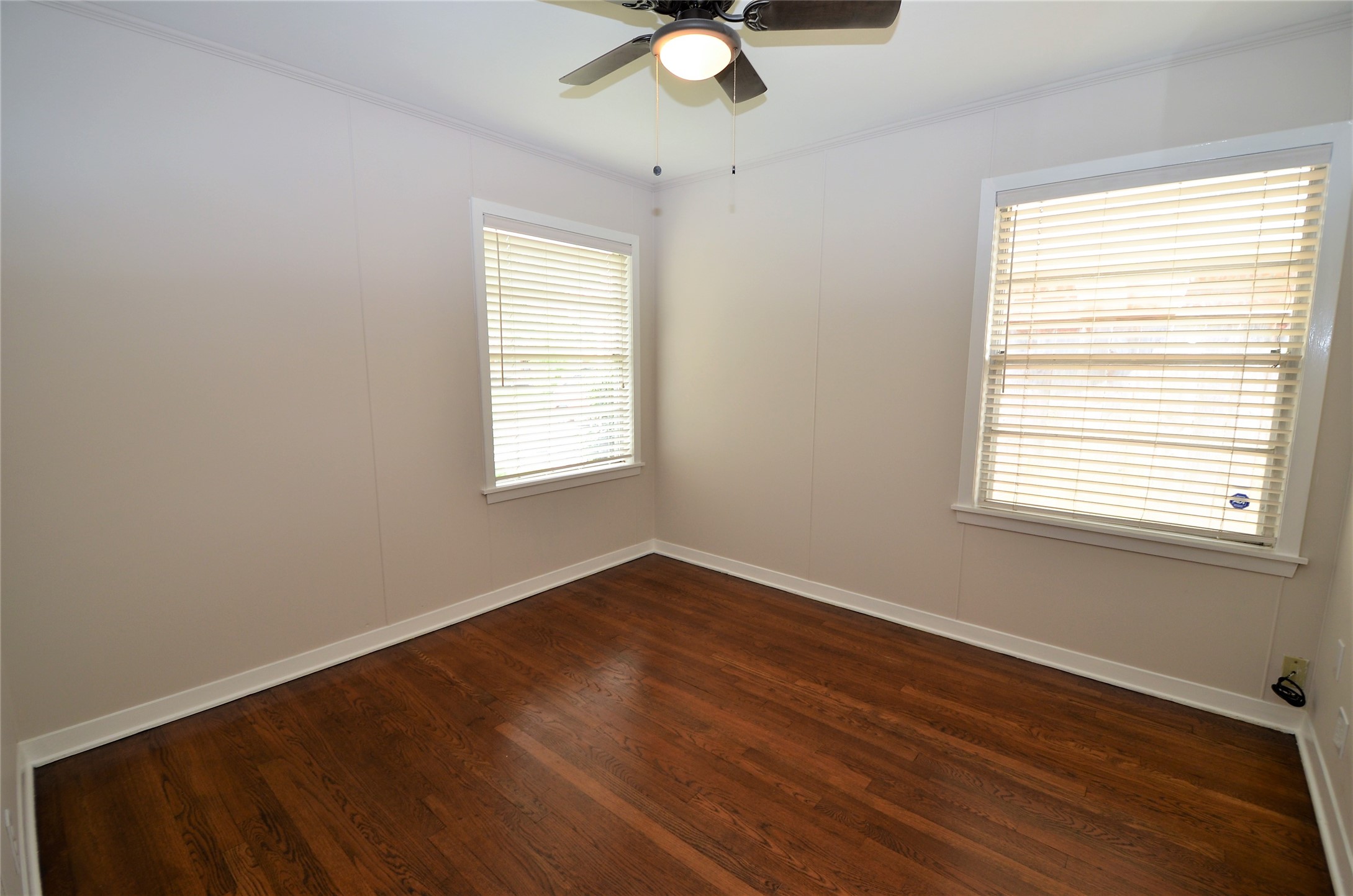 Front bedroom with ceiling fan and lots of natural light.