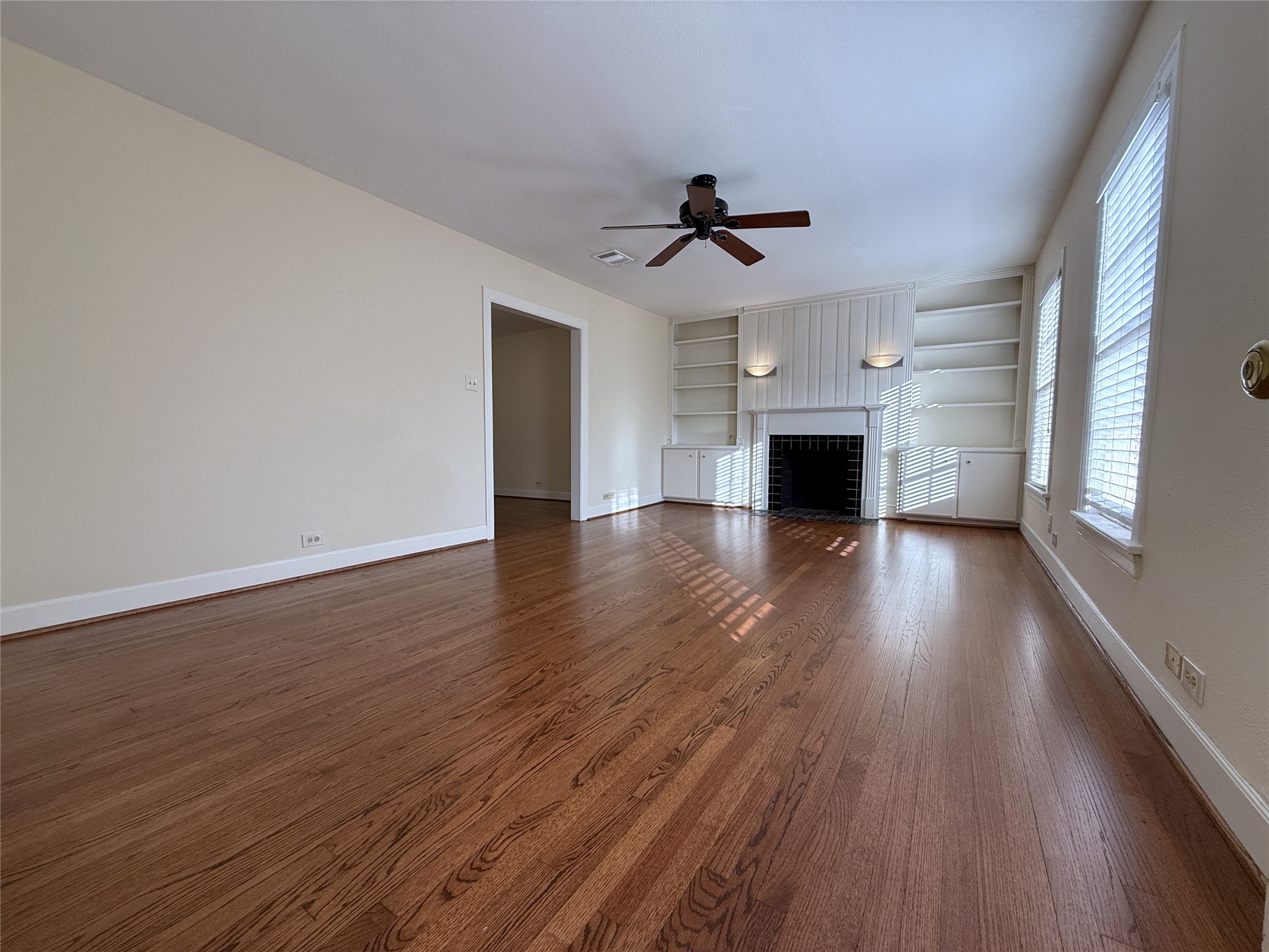 Welcome home! The living room offers a ceiling fan, mock fireplace, built-in cabinets/shelving & sconce lighting. Welcome home! The living room offers a ceiling fan, mock fireplace, built-in cabinets/shelving & sconce lighting.