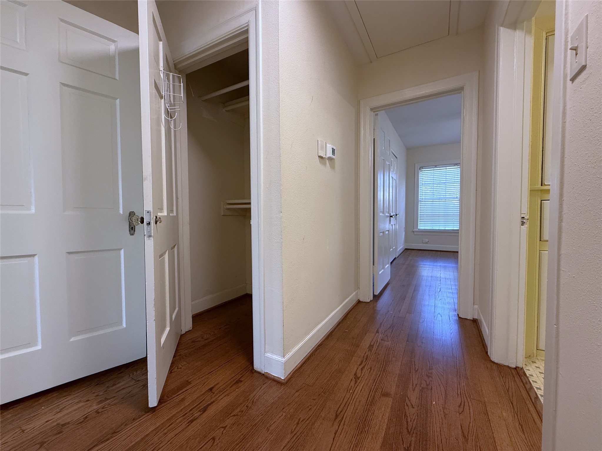 The hallway offers a nicely sized closet with double bars.