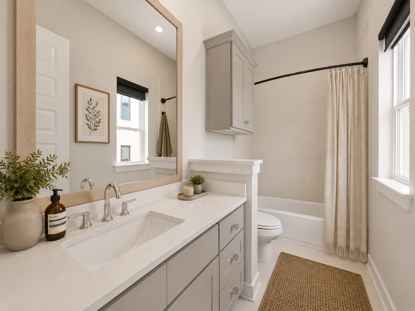 Secondary bathroom featuring modern finishes, vanity storage, and private en-suite access.