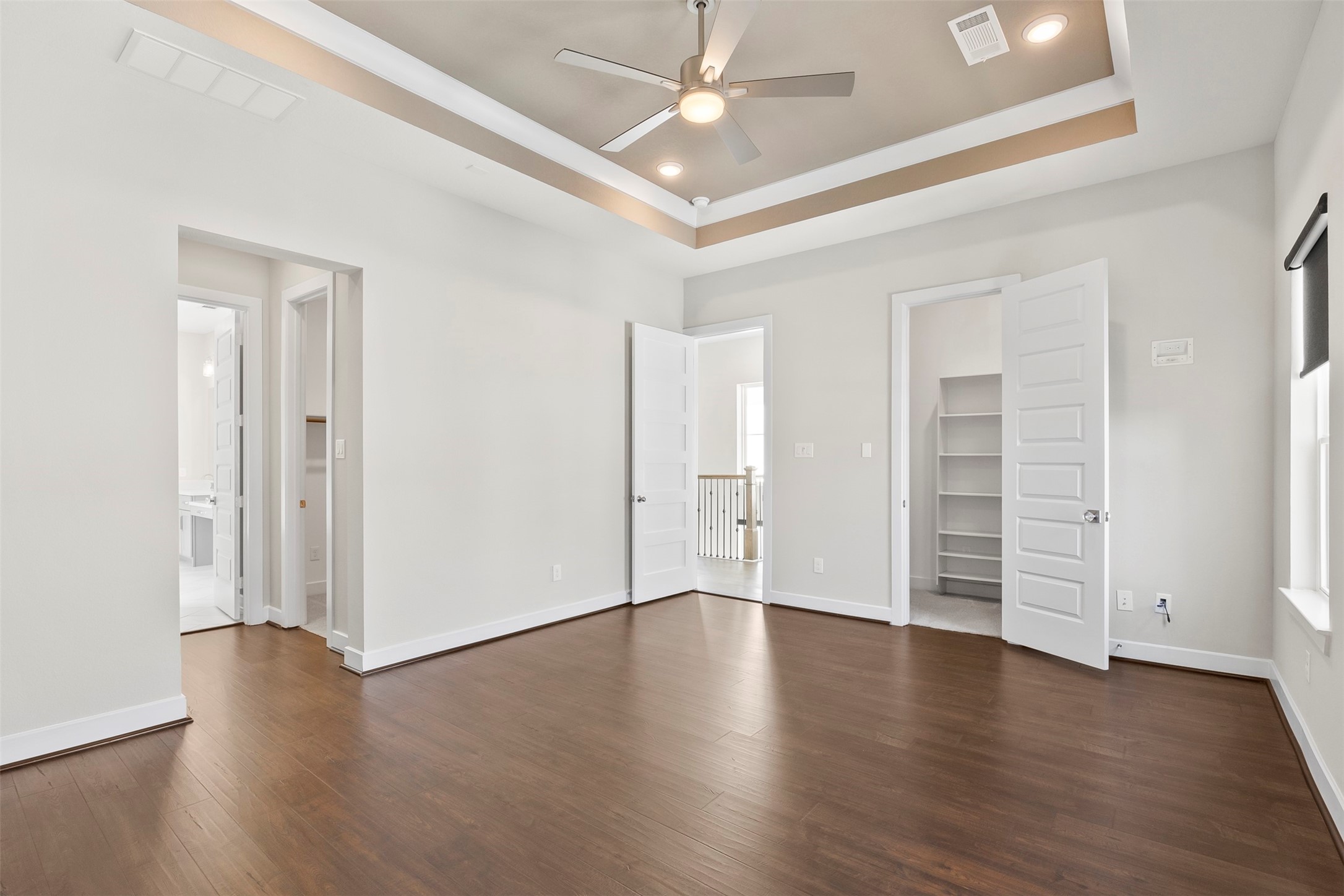 Additional view of the primary suite highlighting generous dimensions, tray ceilings, and flexible layout options.