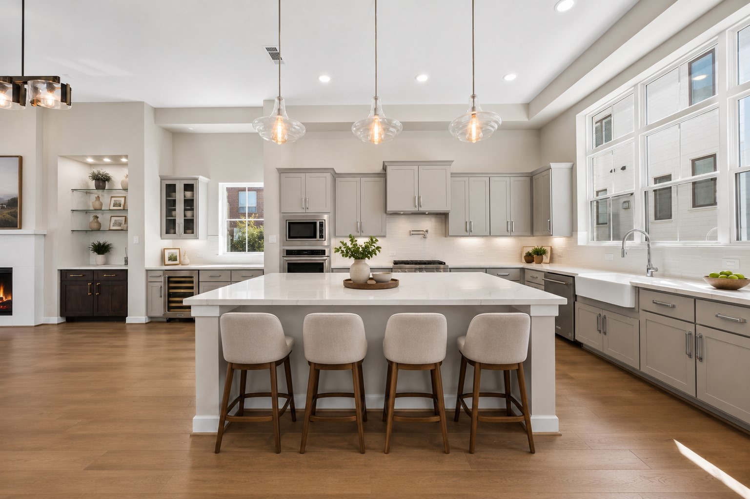 Spacious open-concept kitchen featuring an oversized quartz island with seating, abundant cabinetry, stainless steel appliances, and an ideal layout for everyday living and entertaining. Spacious open-concept kitchen featuring an oversized quartz island with seating, abundant cabinetry, stainless steel appliances, and an ideal layout for everyday living and entertaining.
