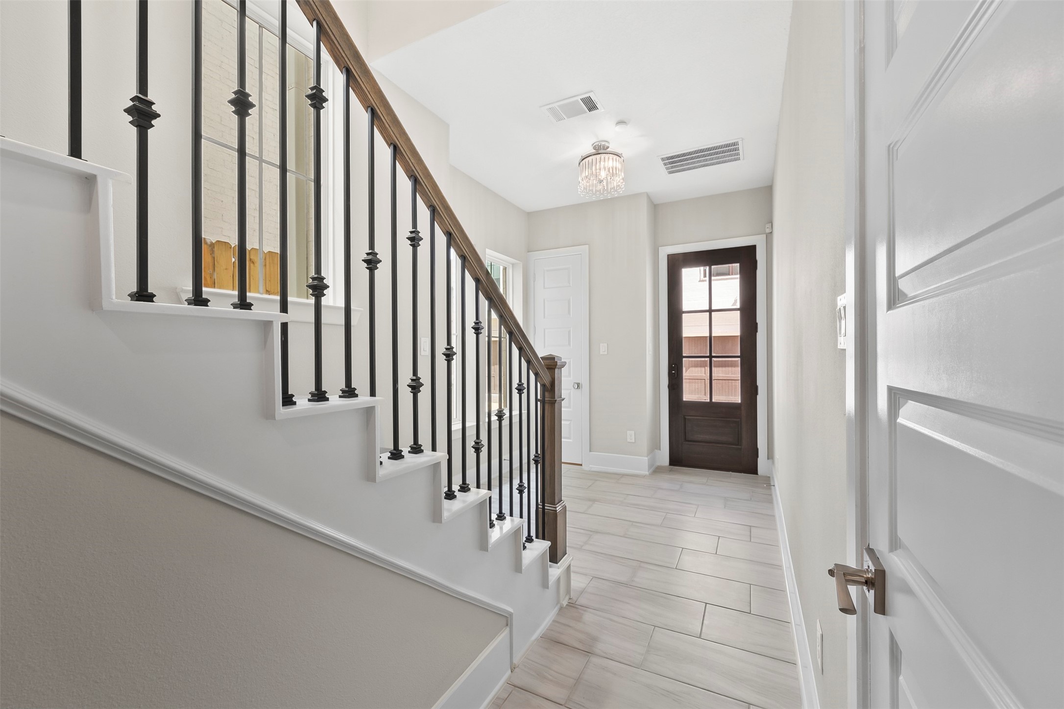 Interior staircase with wood flooring, modern railing, and convenient access to all three levels of the home.