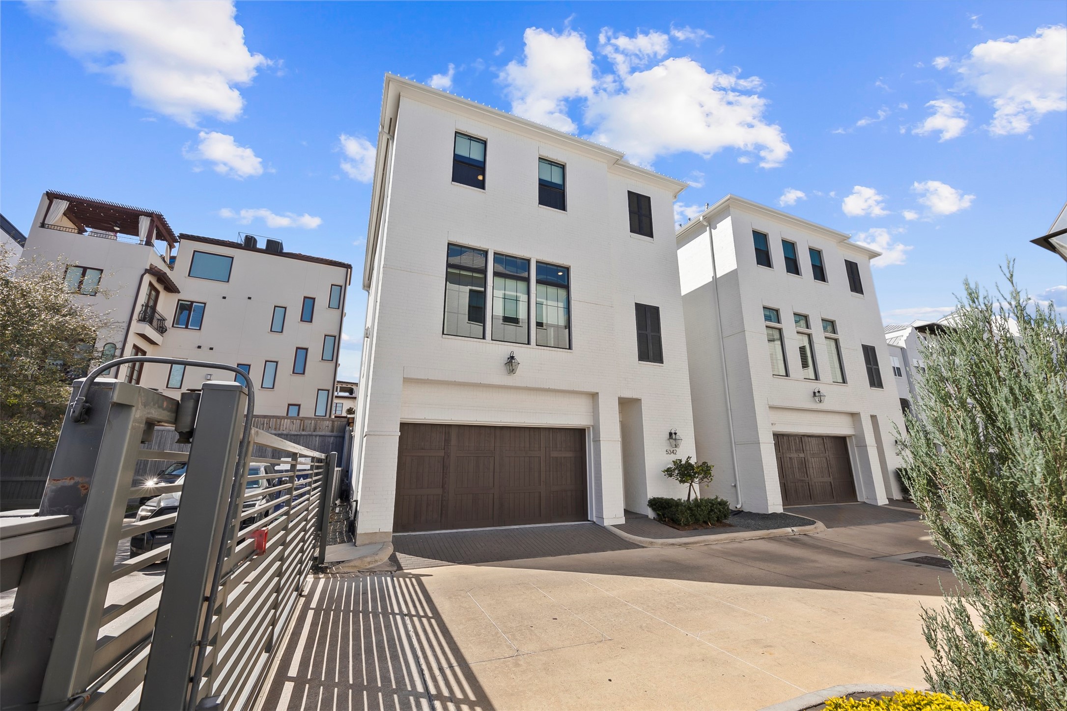 Front elevation highlighting the home's contemporary architecture, corner positioning, and abundant windows that maximize natural light.