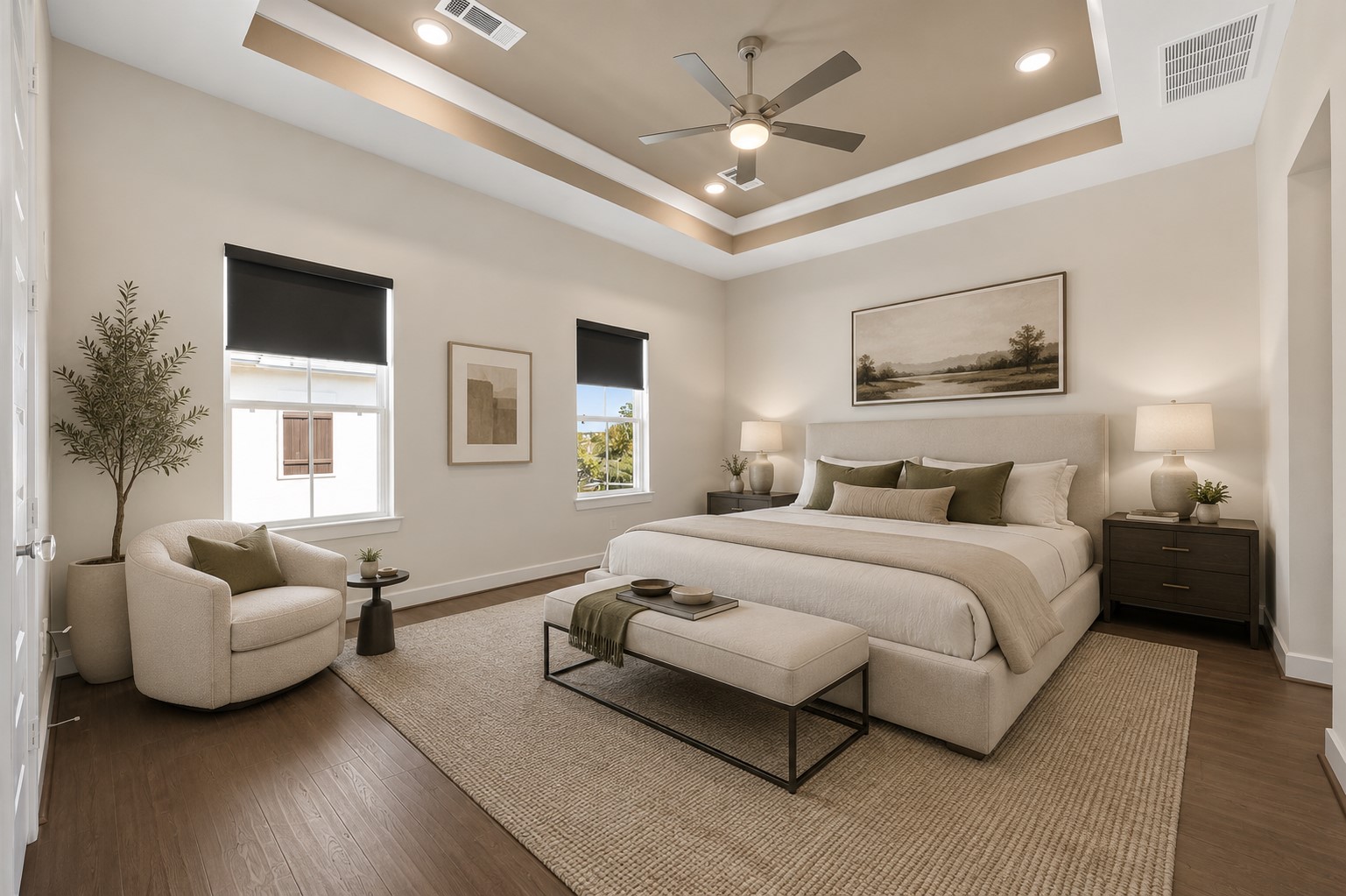 Spacious primary suite featuring tray ceilings, abundant natural light, and generous proportions designed for comfort. Furniture shown has been virtually staged for illustrative purposes. Spacious primary suite featuring tray ceilings, abundant natural light, and generous proportions designed for comfort. Furniture shown has been virtually staged for illustrative purposes.