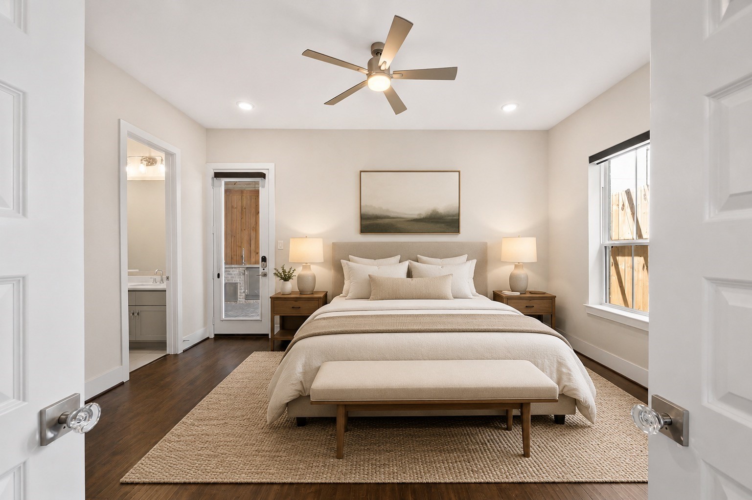 First-floor guest suite providing privacy and convenient access to the outdoor entertaining area. Furniture shown has been virtually staged for illustrative purposes.