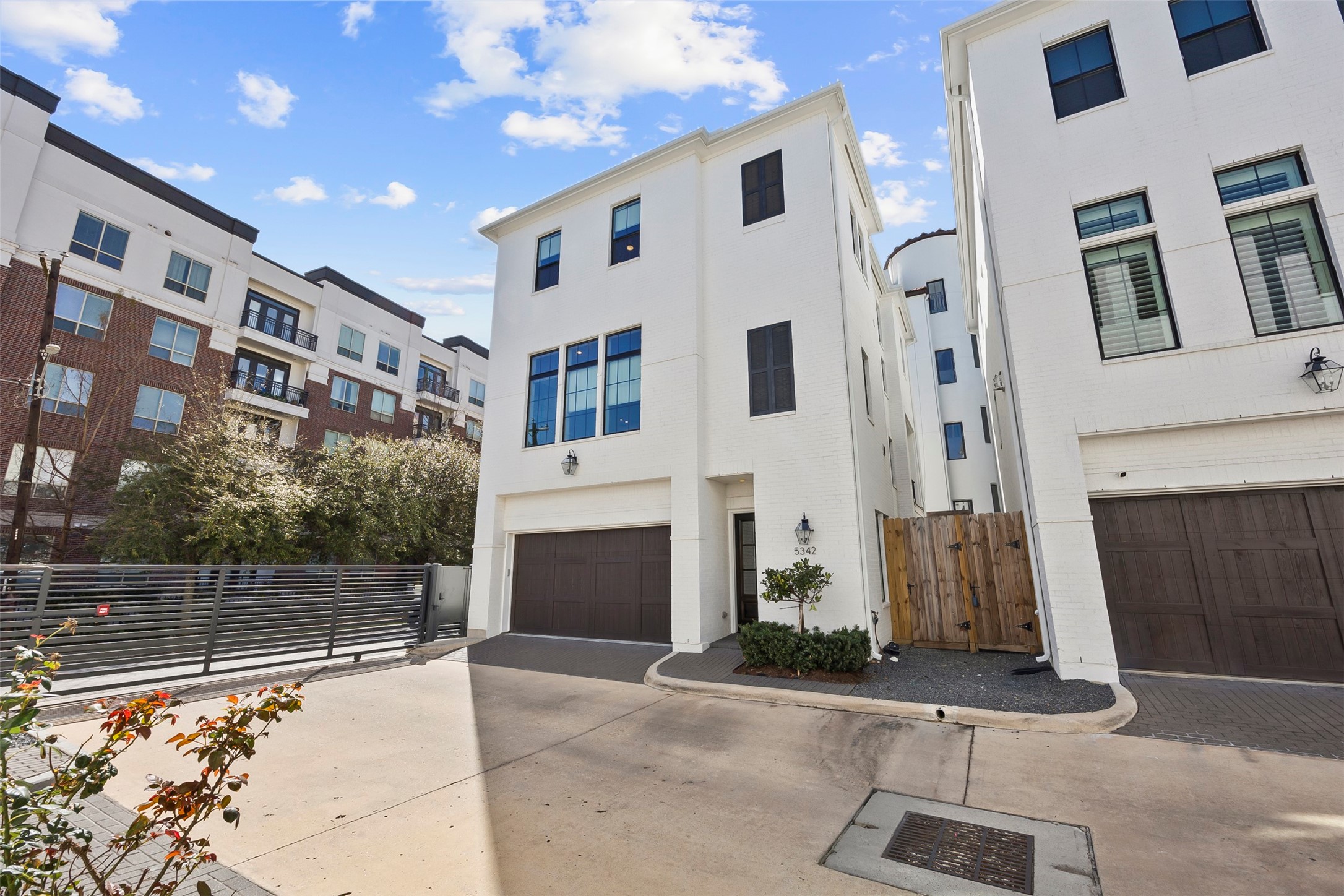 Gated private driveway leading to the attached three-car tandem garage, providing additional privacy and convenience.
