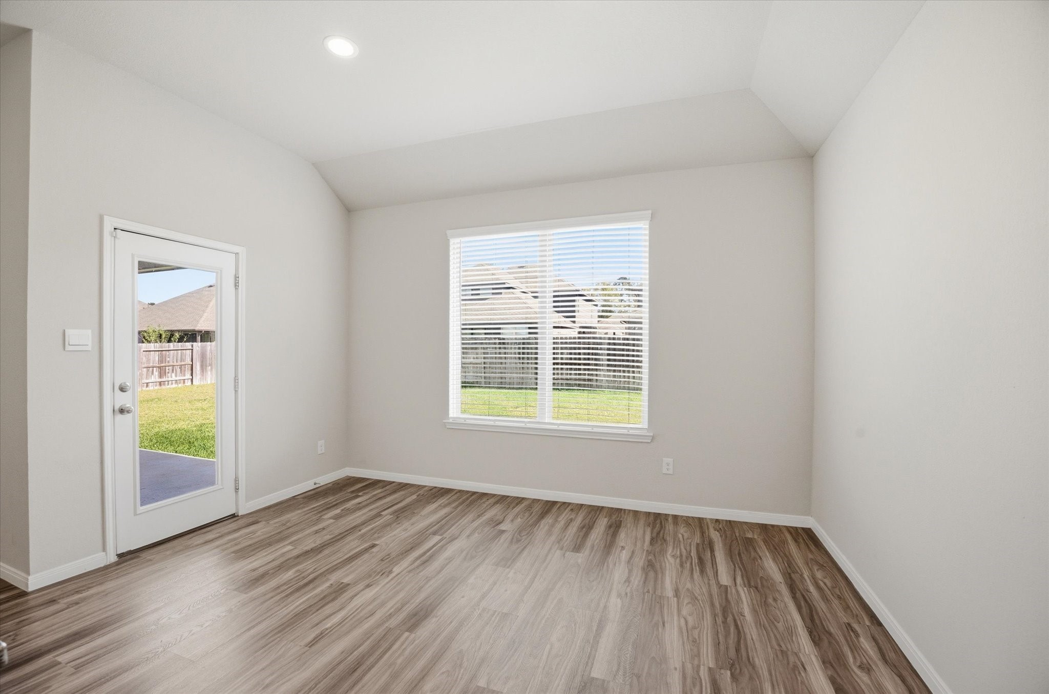 This cozy dining area offers a warm atmosphere with soft carpet underfoot and natural light streaming through the window, perfect for intimate gatherings or quiet meals.