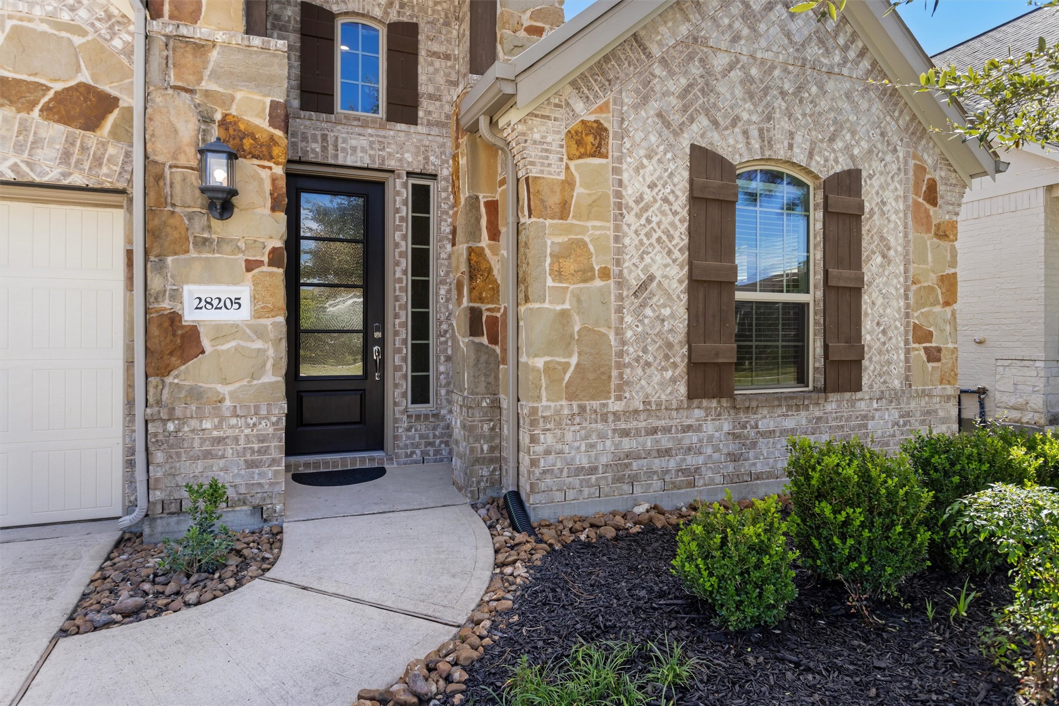 Covered front porch entry. Great curb appeal with brick and stone facade