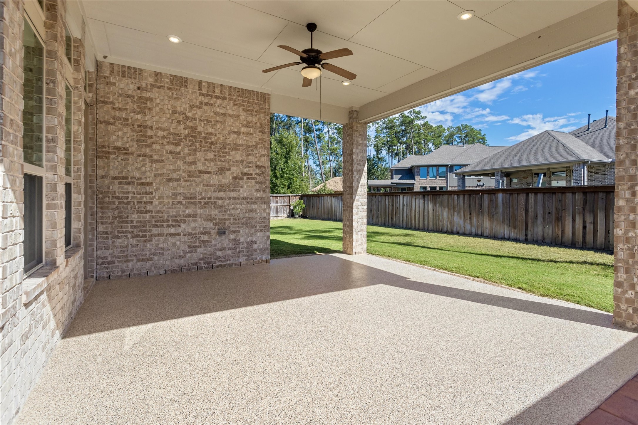 Extended and covered back patio with epoxy floor.