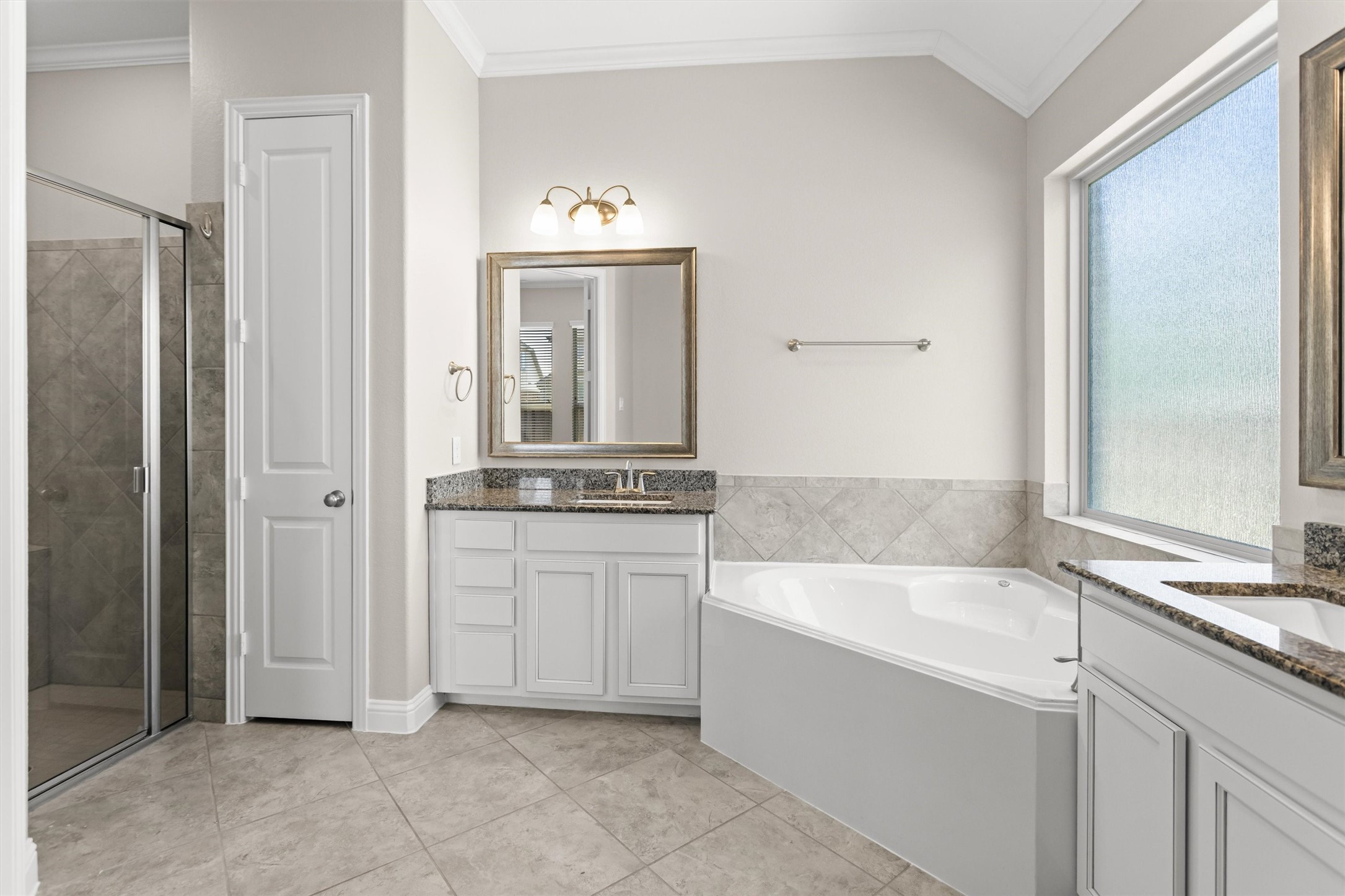 Separate shower with glass doors. Linen closet too.