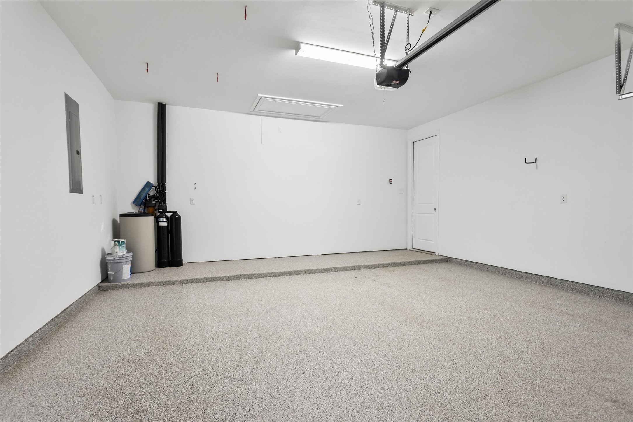 Attached 2 car garage with upgraded epoxy floors. The whole home water softener is included.