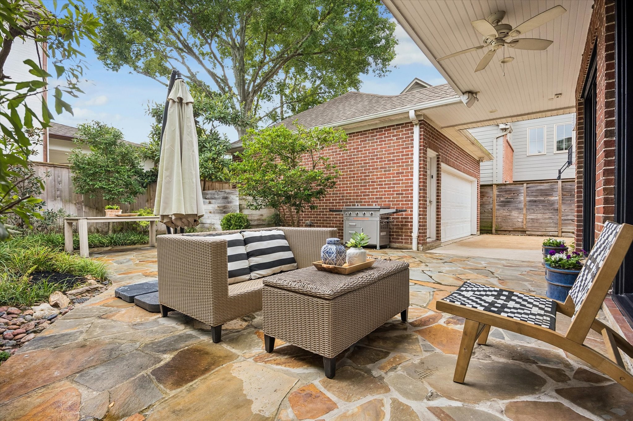 Enjoy this backyard & patio...a grill and tv convey with home. This lovely area is low maintenance and turn-key.