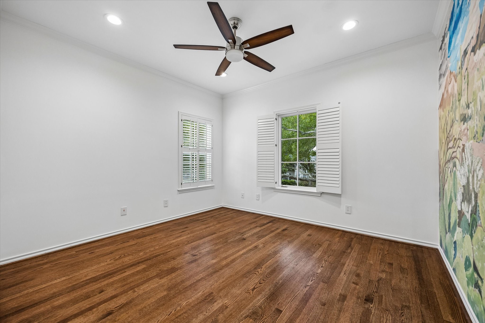Handsome secondary bedrooms with 2026 paint, hardwoods & plantation shutters.