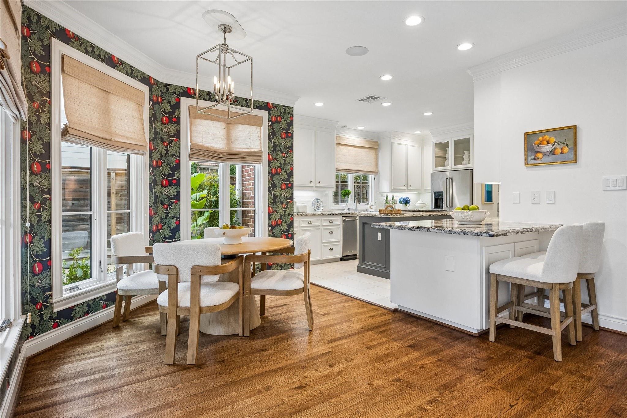 The light and bright breakfast area is nicely appointing with designer lighting and wallpaper.