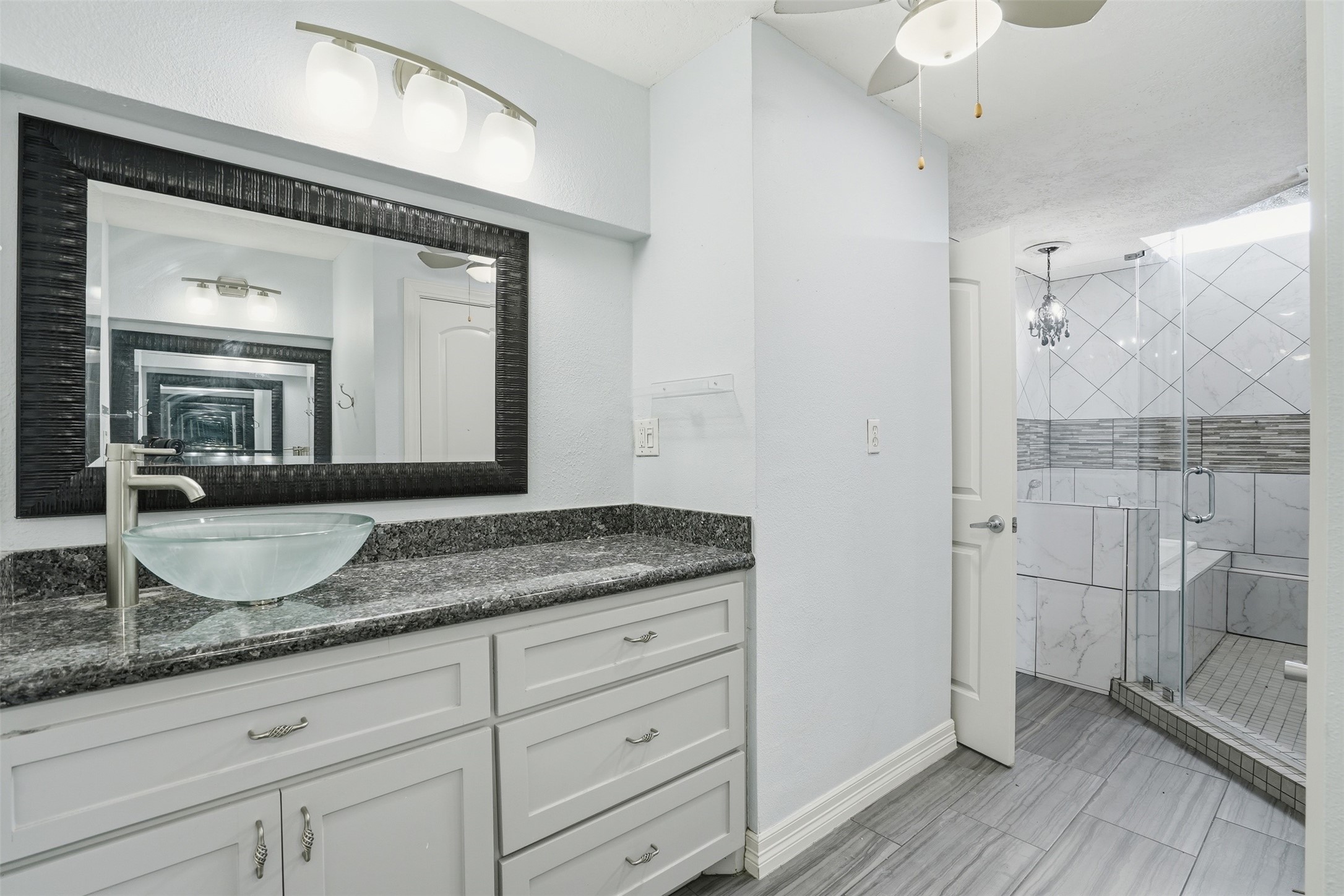 Primary bath offers excellent storage with cabinetry beneath each vanity, providing both style and everyday convenience.