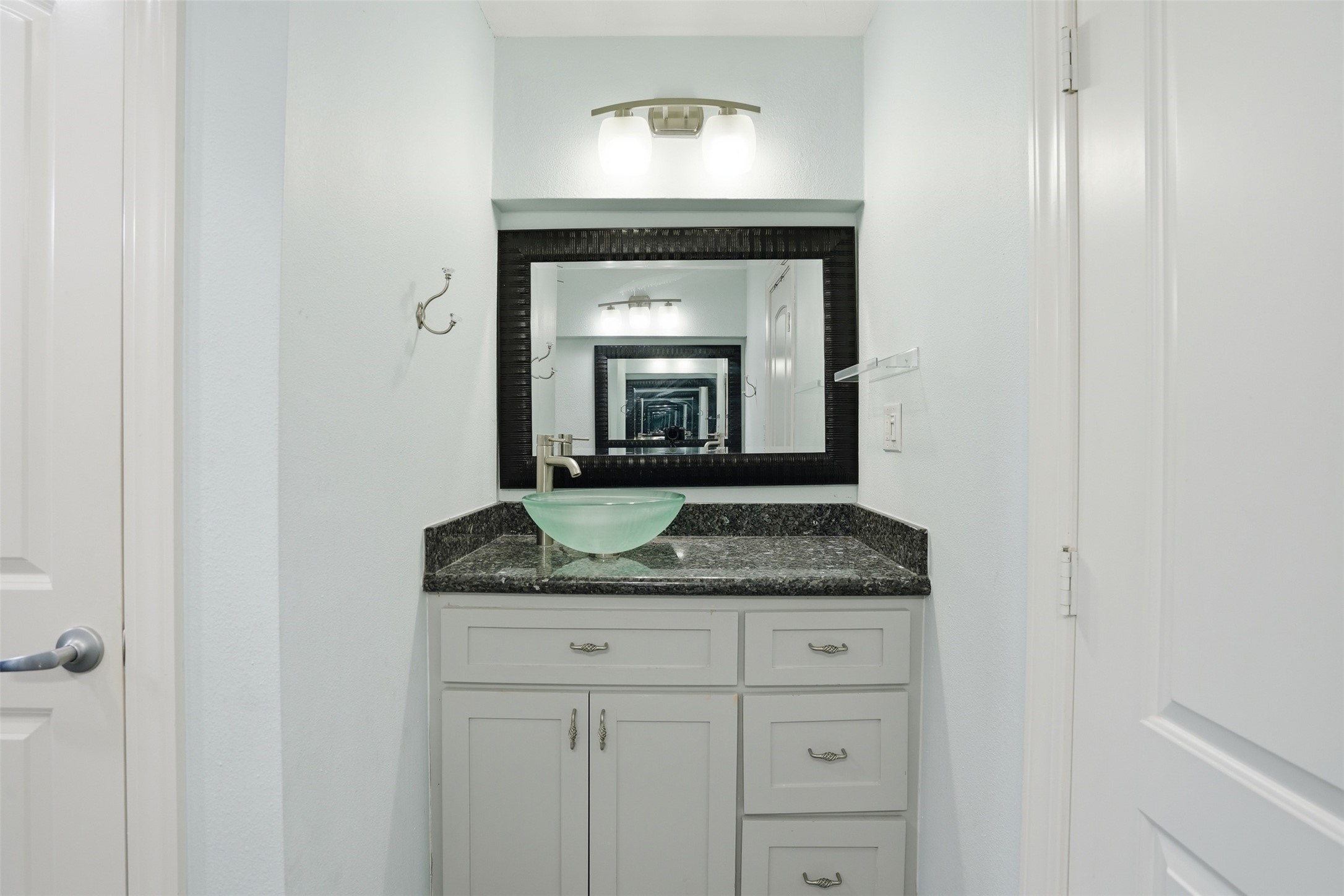 Primary bath vanity area features granite countertops and two separate vanity spaces for added convenience.