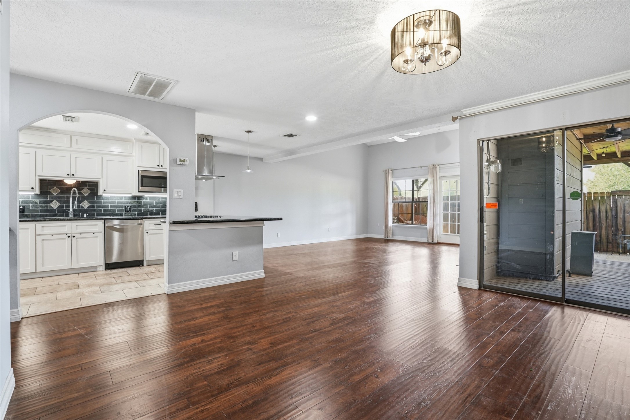 Spacious open concept living area with a bright, airy feel and abundant natural light. Seamless flow to the outdoor patio creates the perfect setup for relaxing or entertaining.