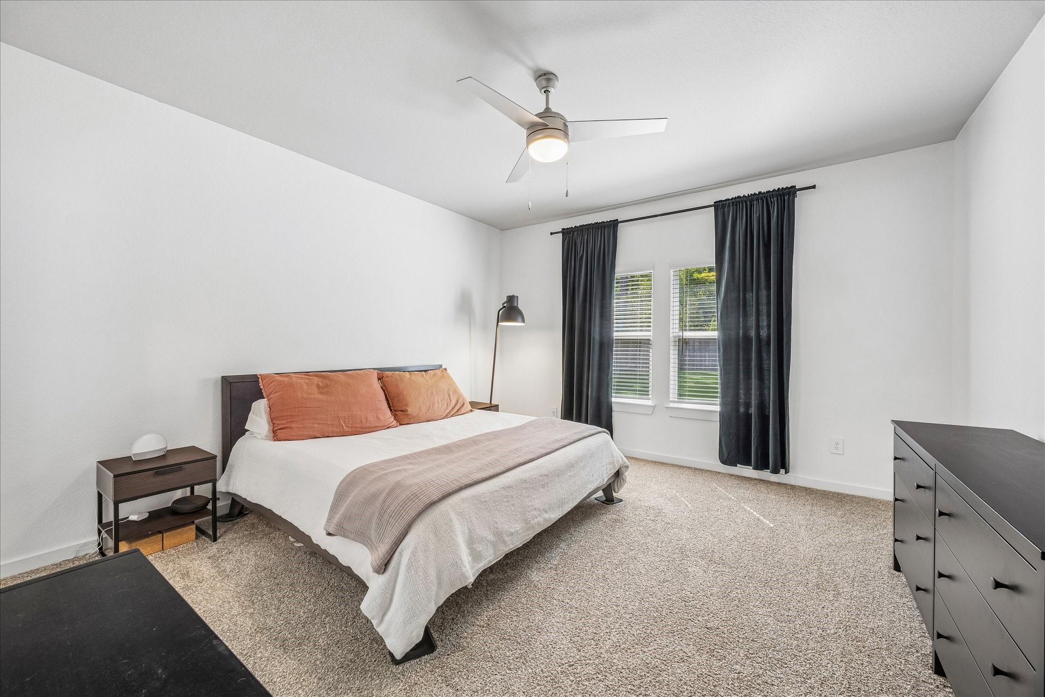 The primary bedroom is spacious and bright. You will love waking up to views of nature.