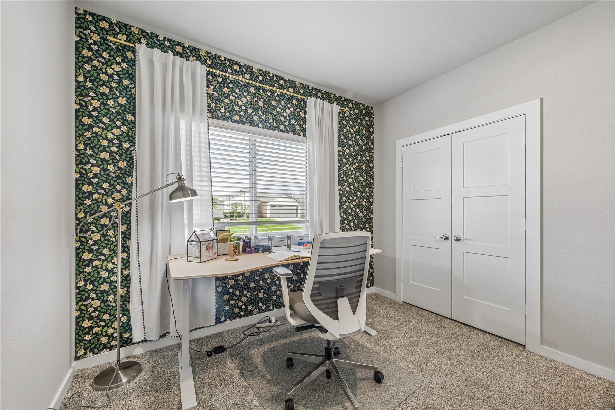 Second bedroom downstairs. Currently used as a home office. Designer wall paper accents.