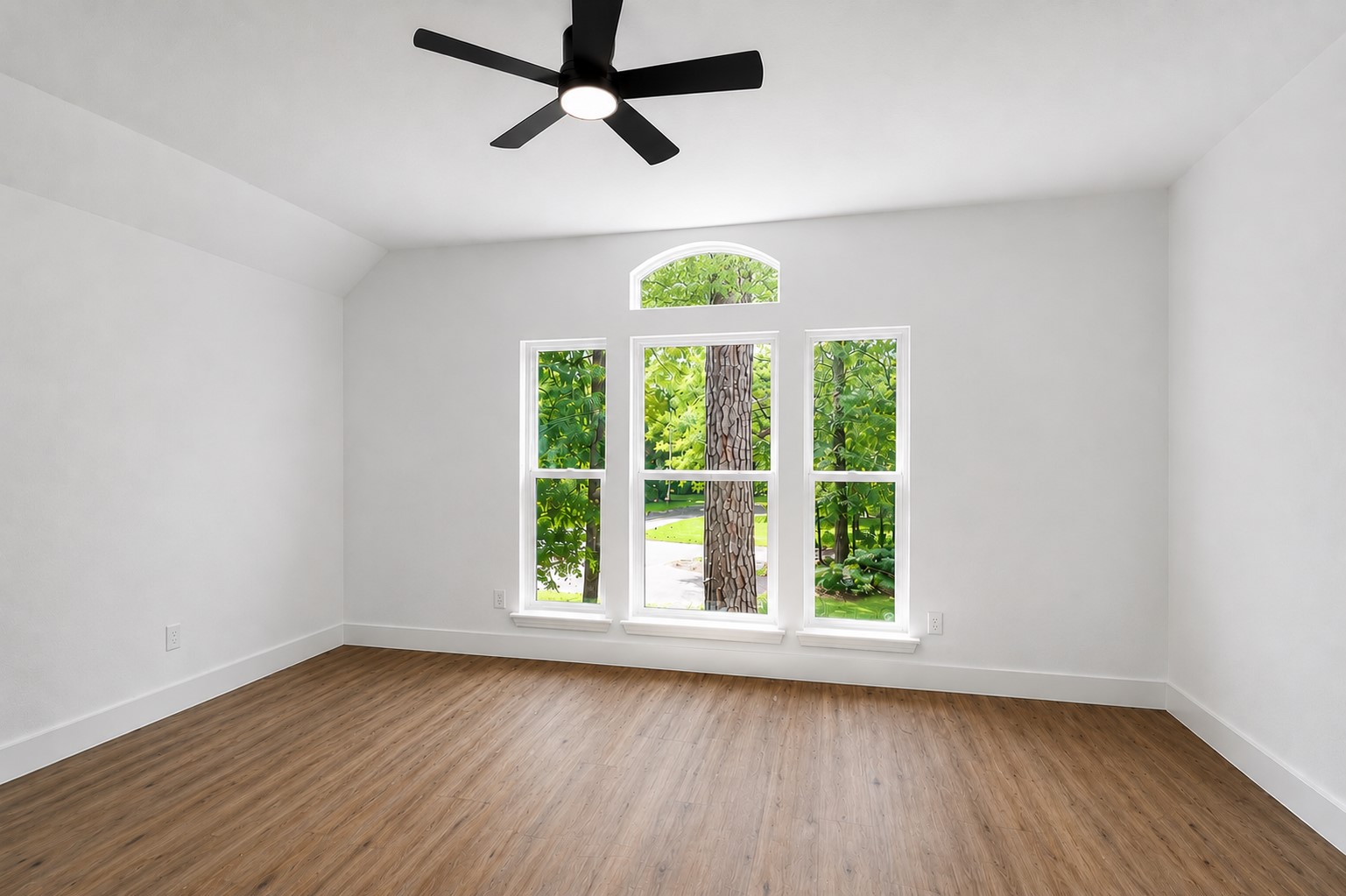 Secondary bright and airy room featuring large windows with scenic views, elegant vinyl flooring, and a modern ceiling fan.
