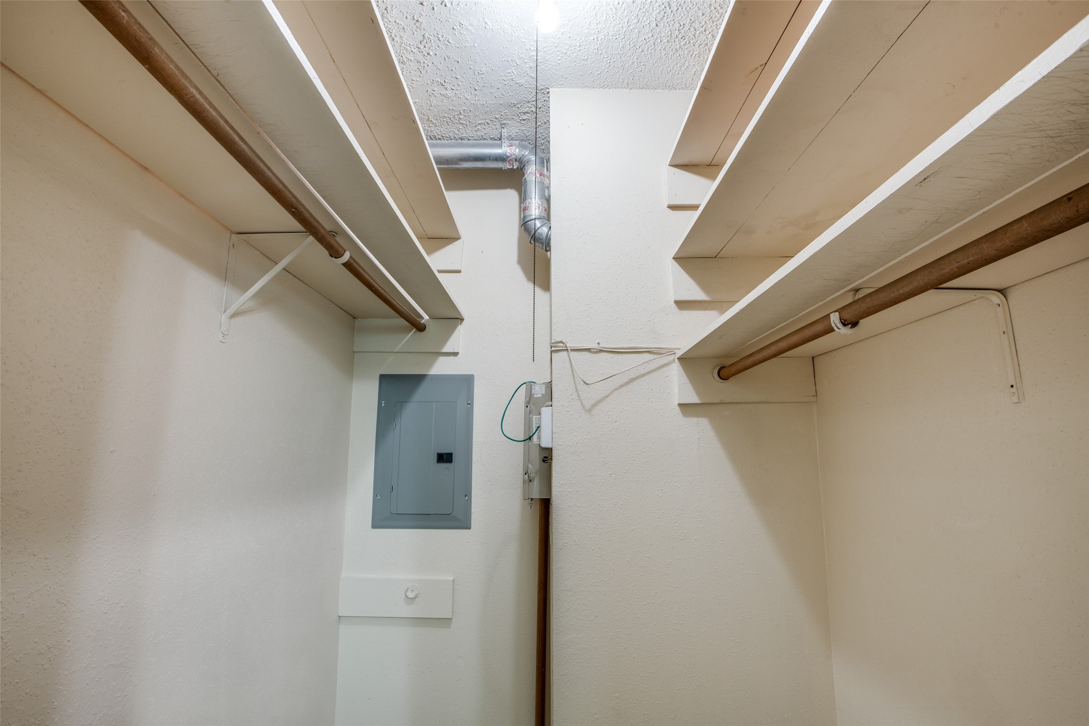Large walk in closet with hanging and shelves