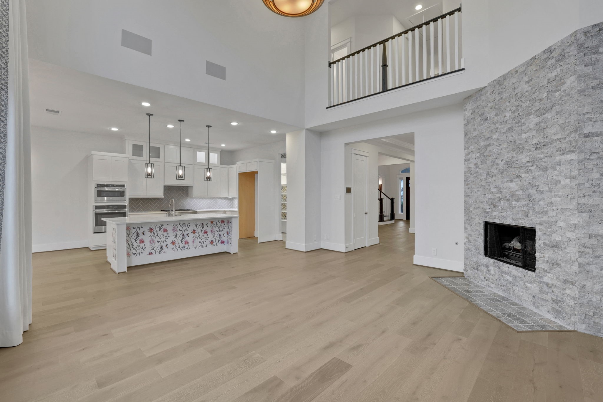 A fireplace and double height ceiling anchor the main living room.