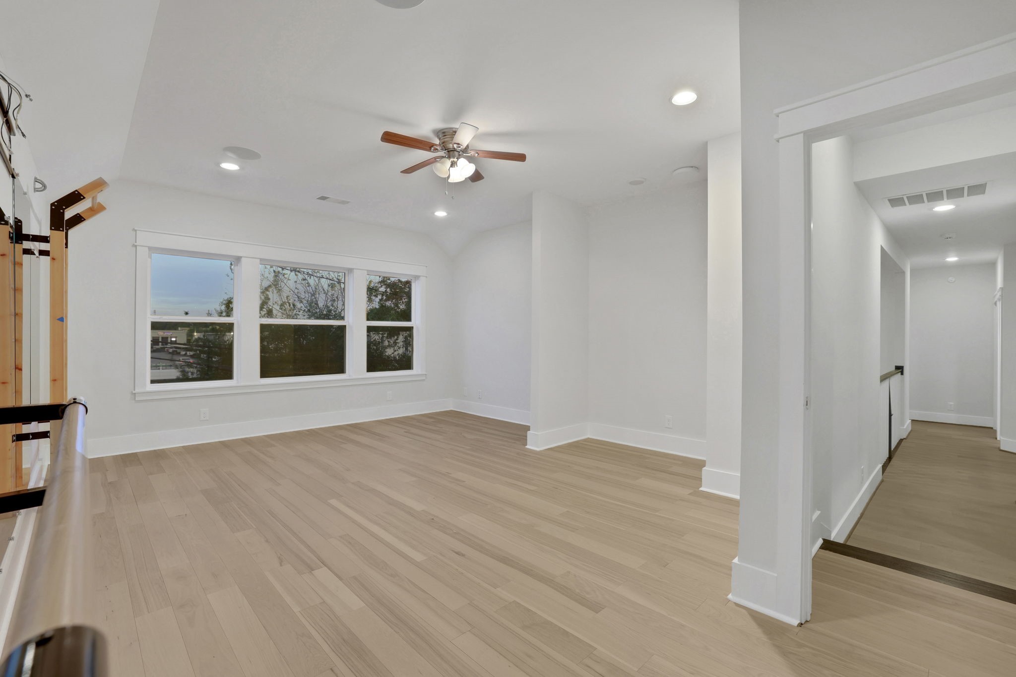 Warm flooring and an open footprint create a flexible space.
