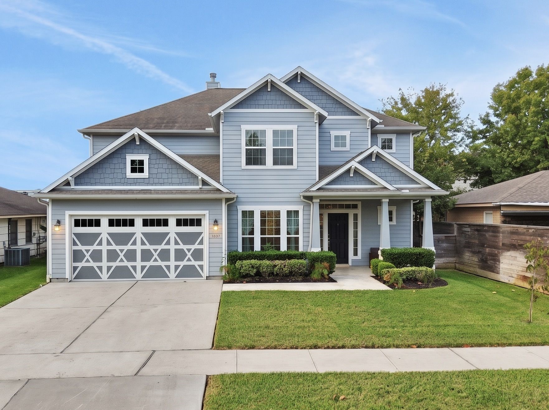 Crisp trim and a carriage style garage door give the front its character.