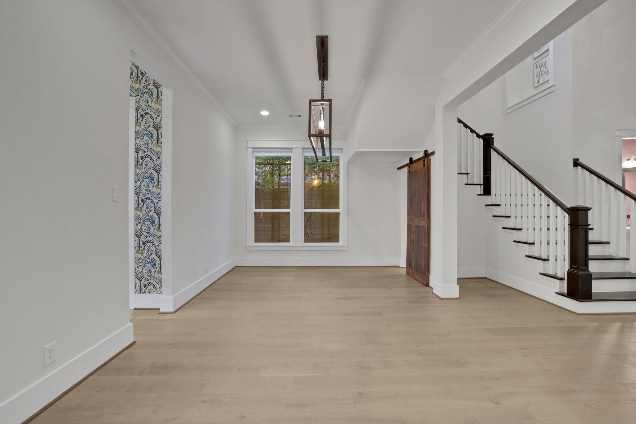 Glass doors and clear sightlines connect the entry to the main living space.