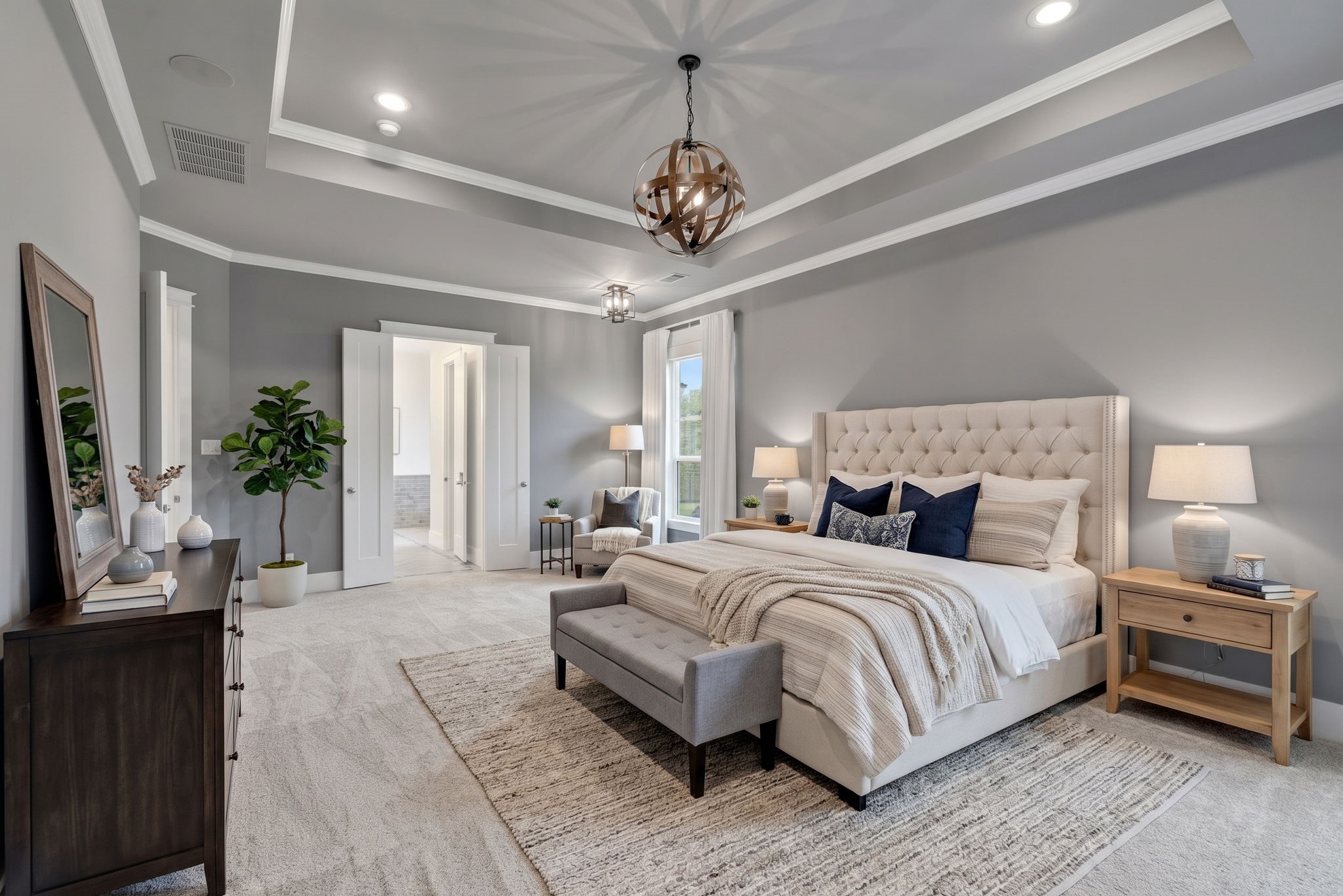 A layered neutral palette brings warmth to the primary bedroom.