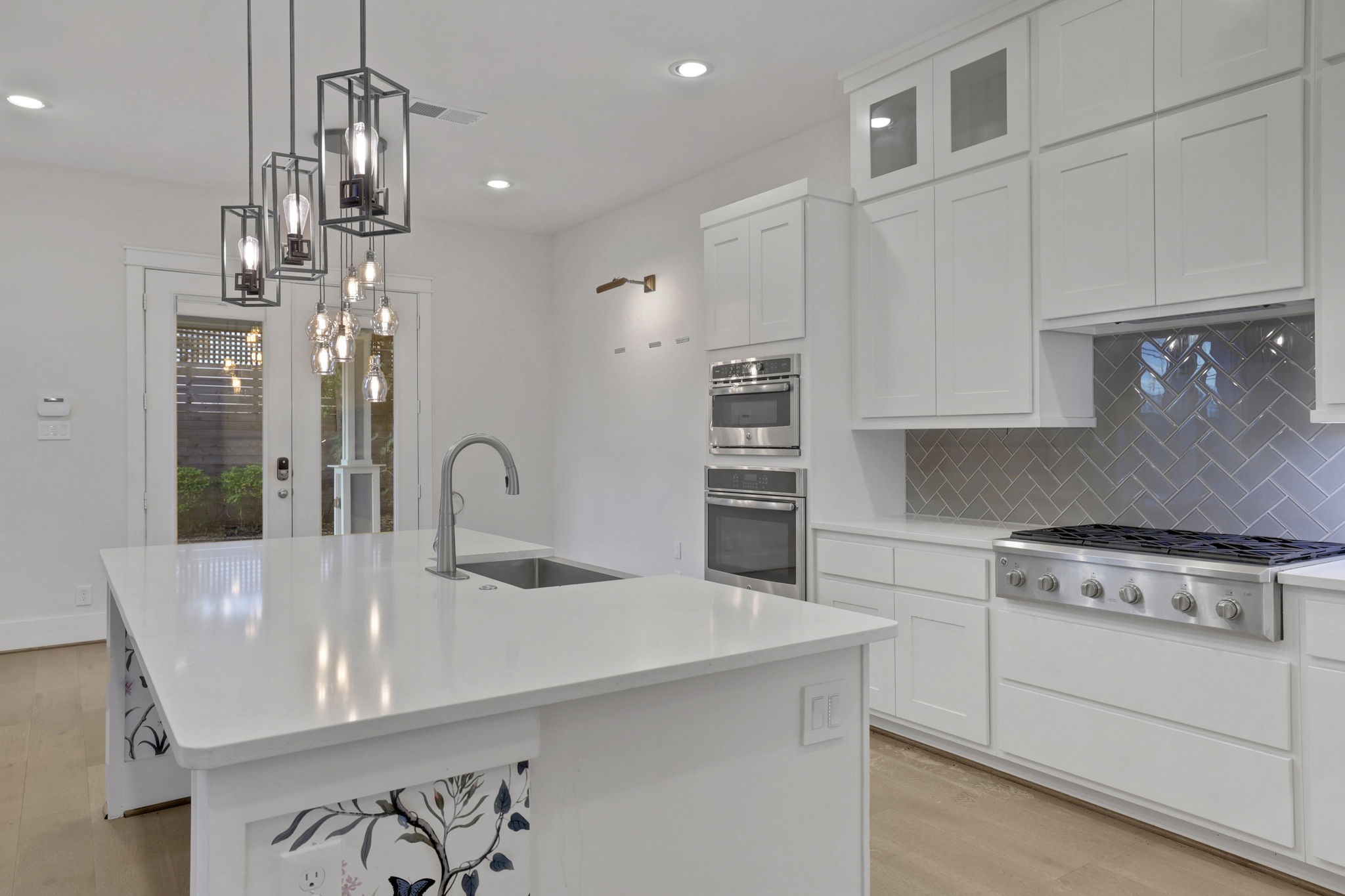Layered cabinetry and pendant lighting define the kitchen.