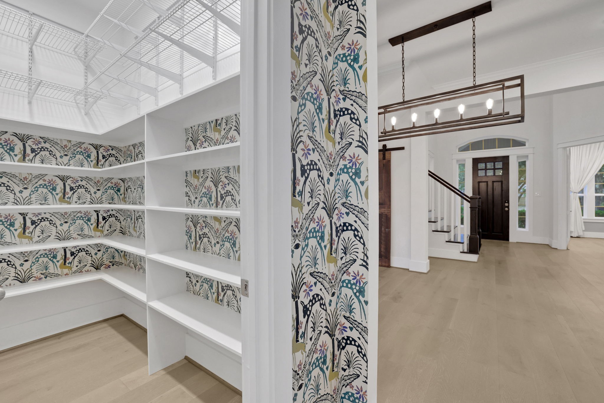 Built in shelving and a sliding door create a dedicated pantry.