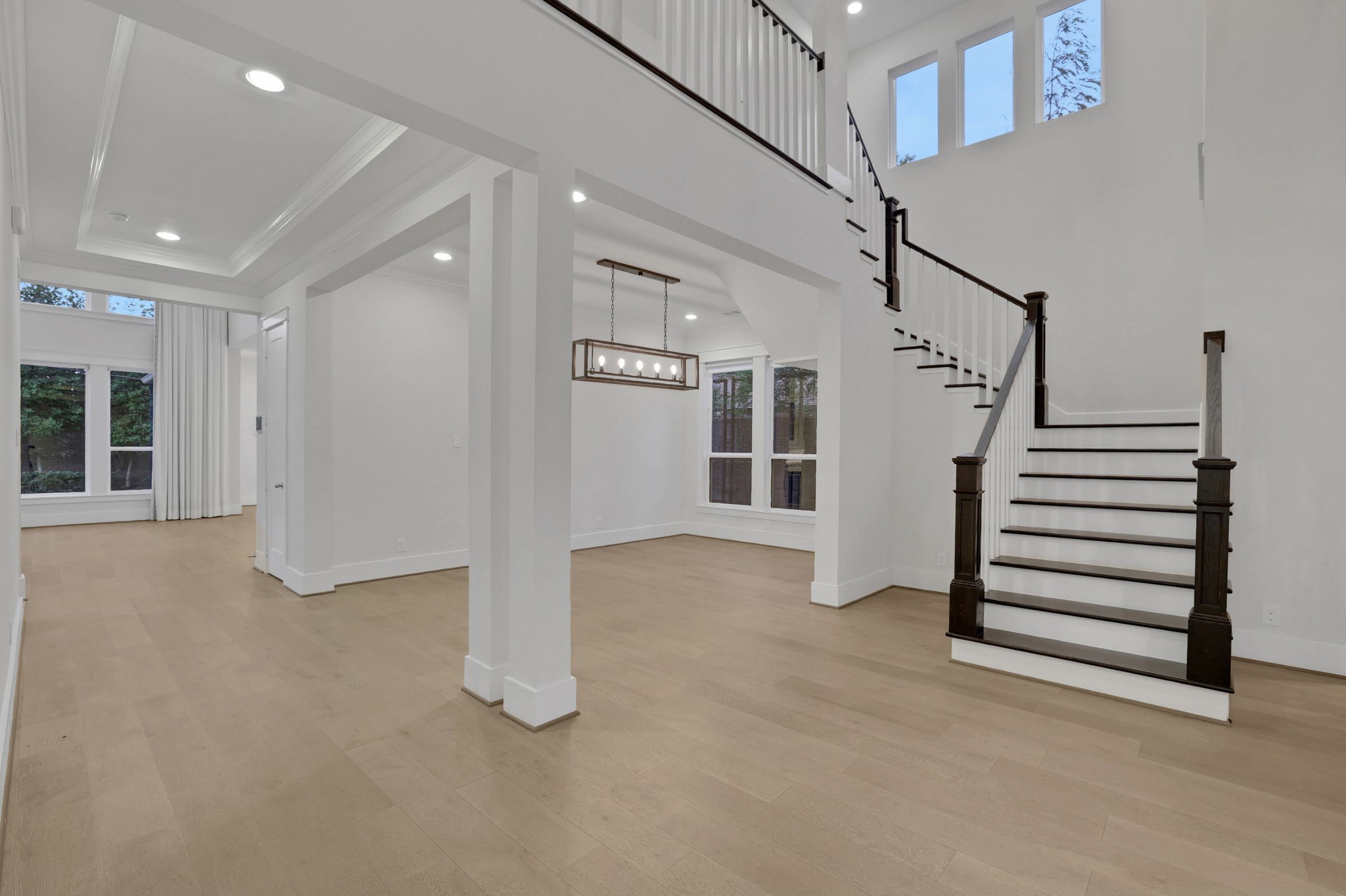 Open sightlines and a staircase anchor the two story entry.