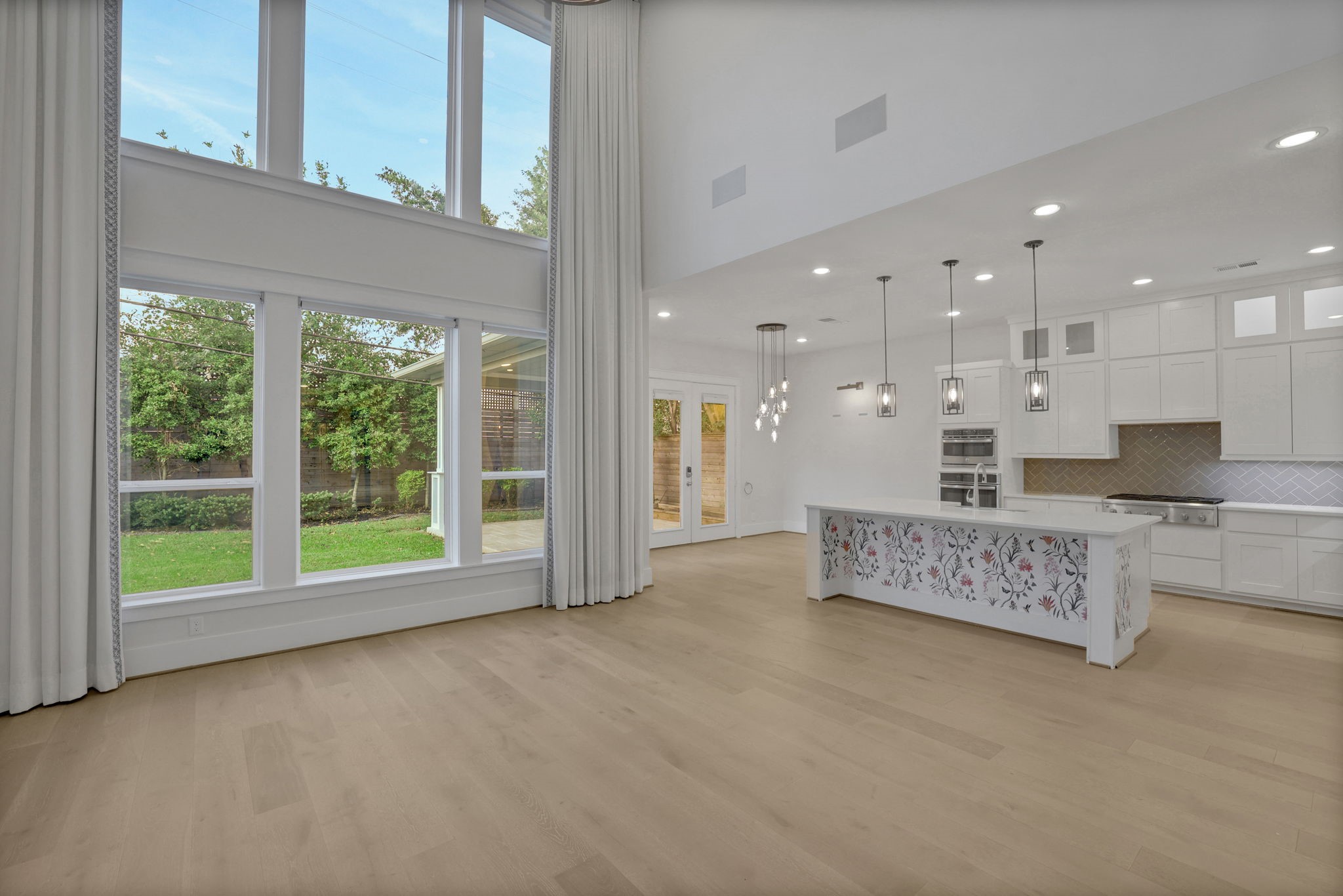 An unfurnished view reveals the proportions and wall of windows.