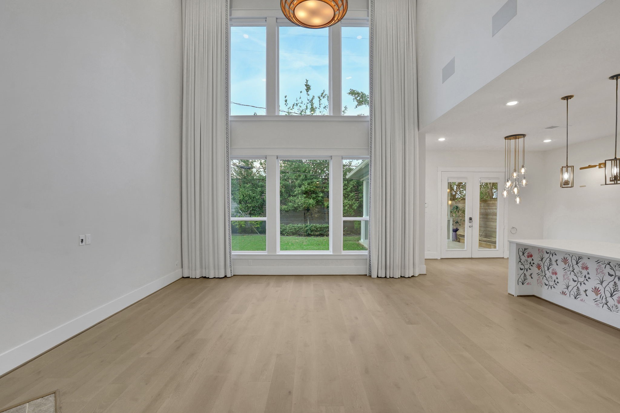 Tall windows and an open footprint leave room to arrange the space.
