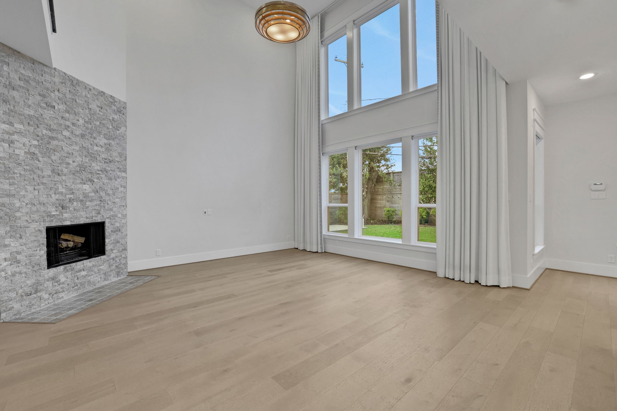 A floor to ceiling fireplace anchors the living room.