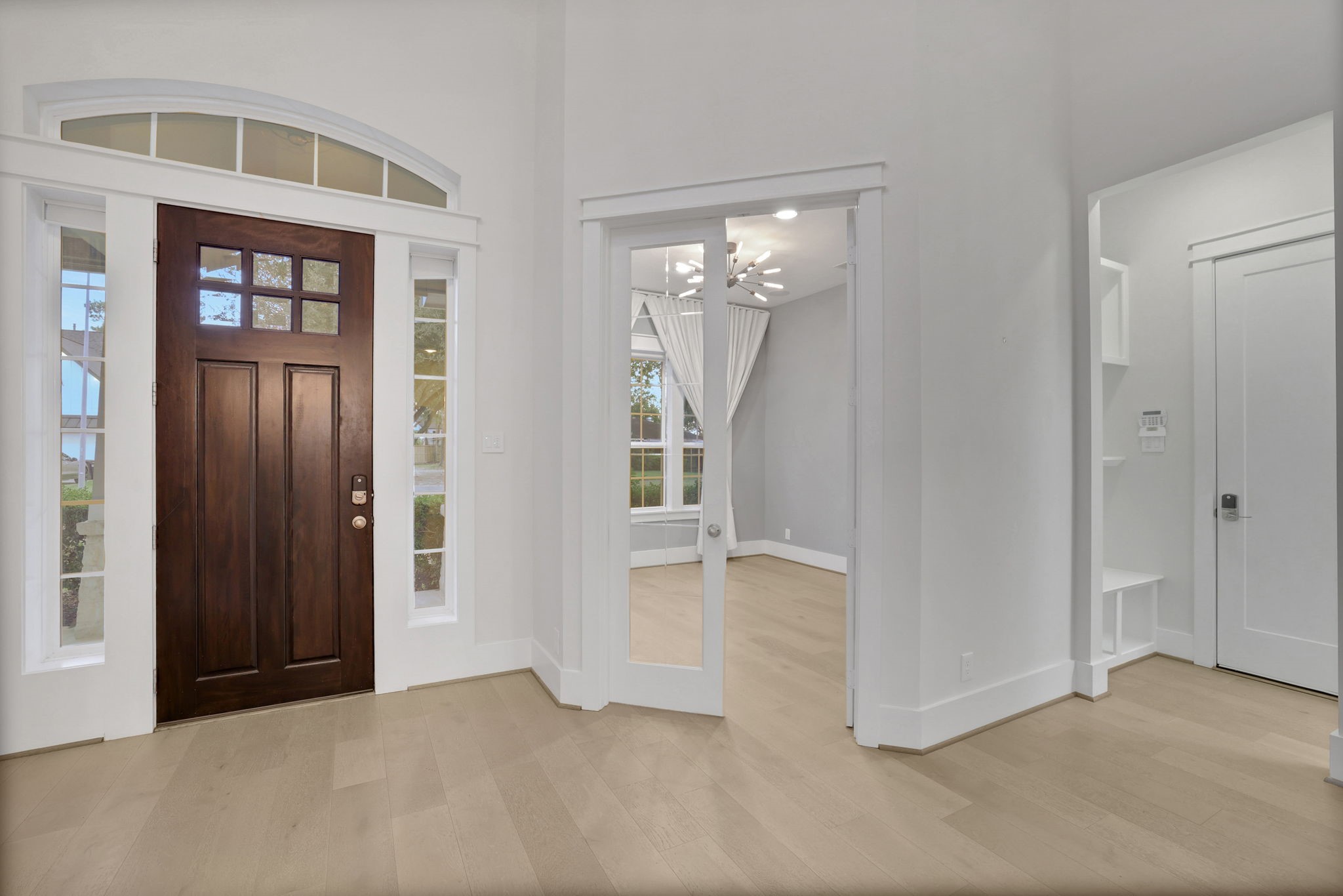 A tall foyer and solid wood front door set the tone inside.