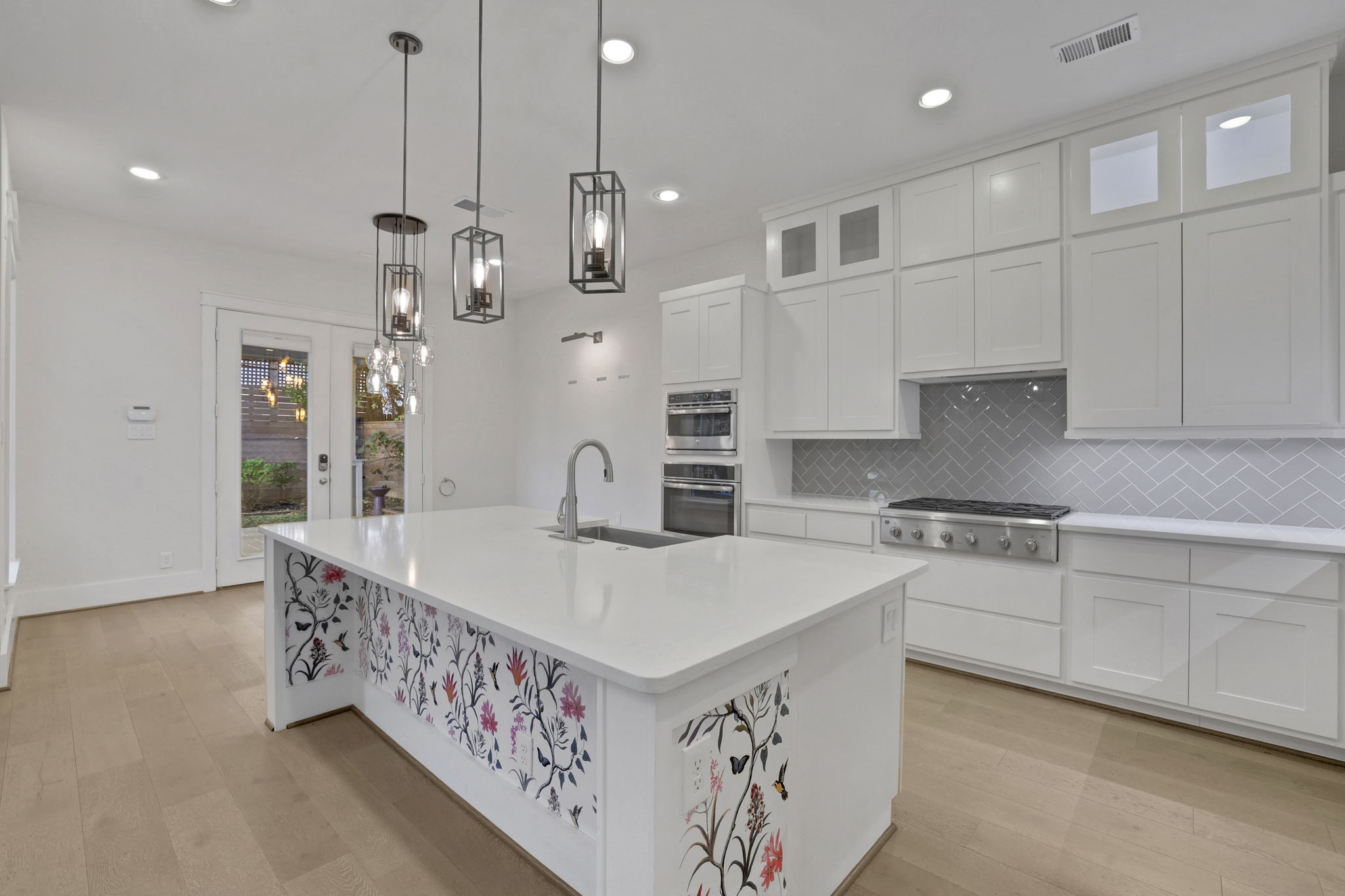 A generous island and pendant lighting center the kitchen.