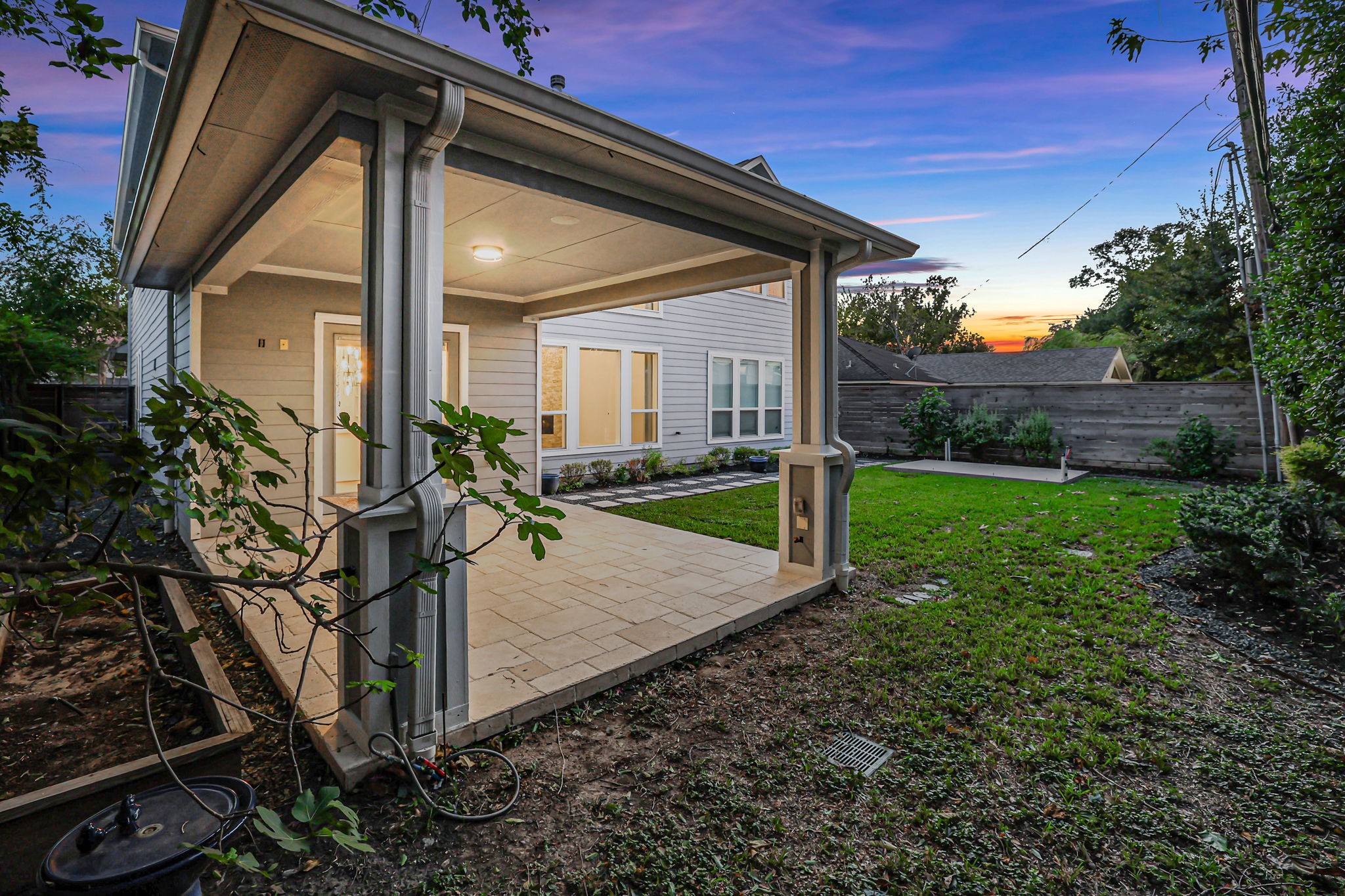 The rear elevation opens onto a lawn with room to enjoy.