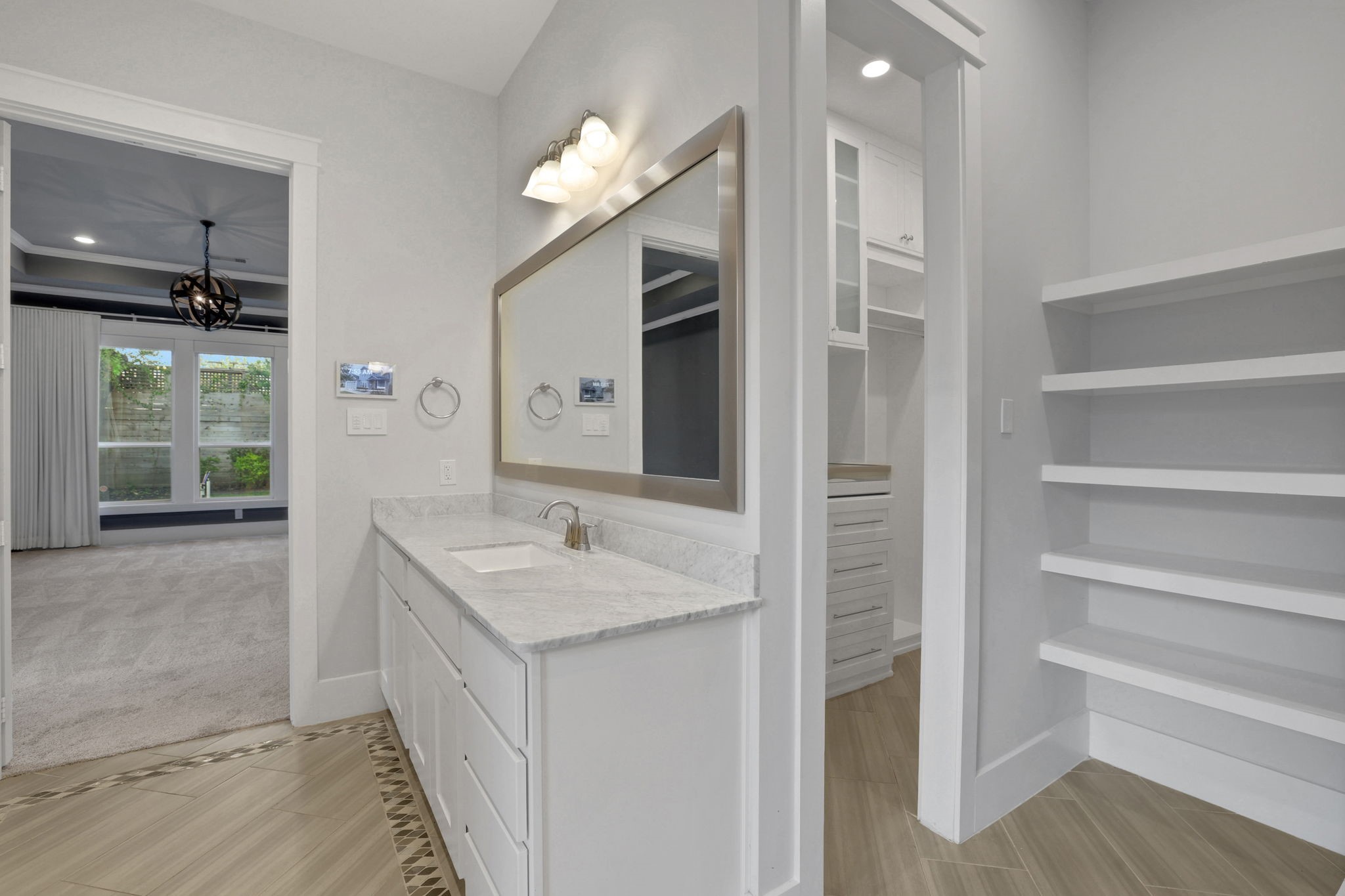 A vanity with direct access to the closet.